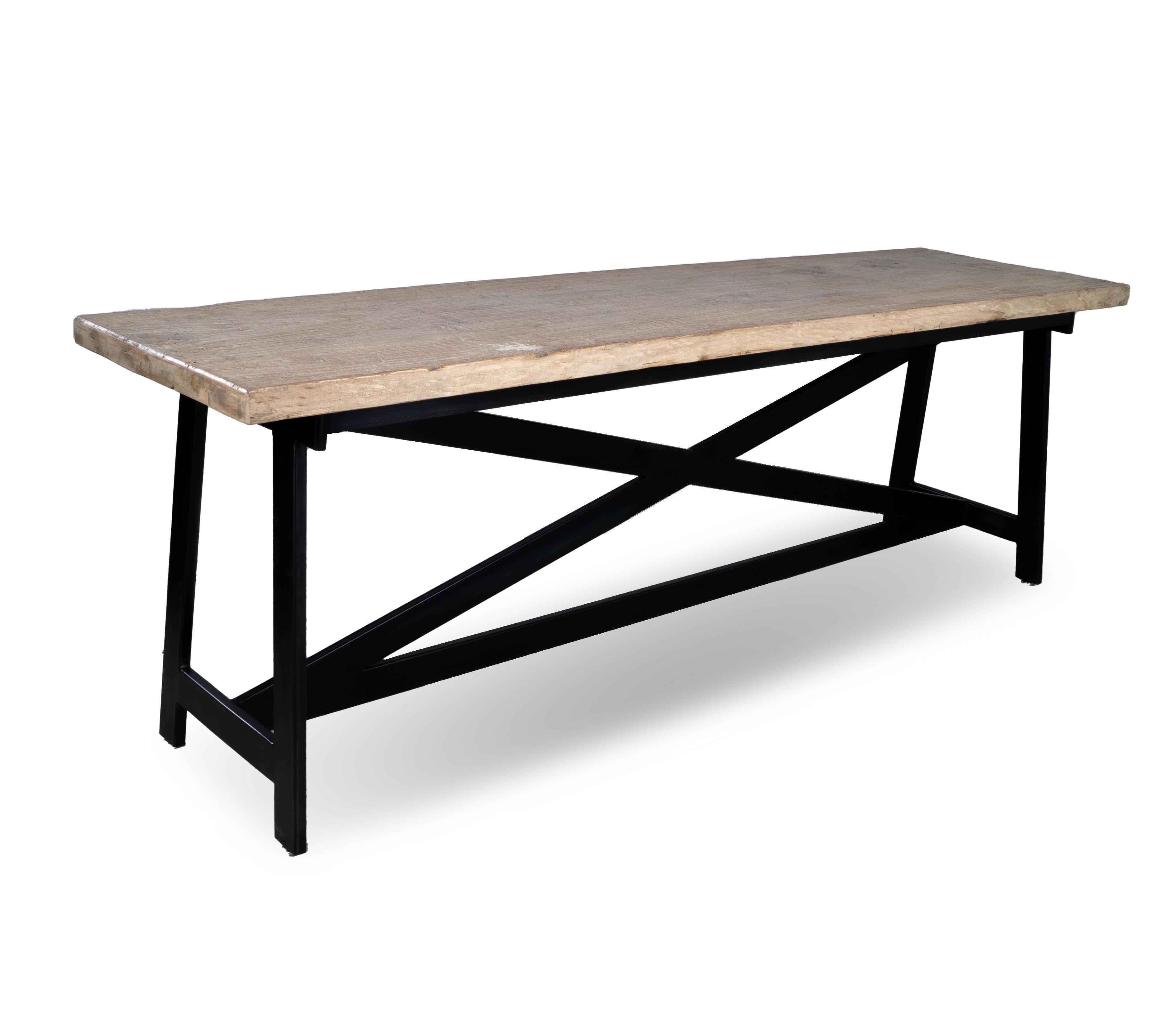 Add a touch of natural beauty and rustic charm to your modern home decor with the Reclaimed Elm Console. Handcrafted with a X stretcher steel sase and a reclaimed and bleached elm top, this console brings timeless elegance to any space. Its