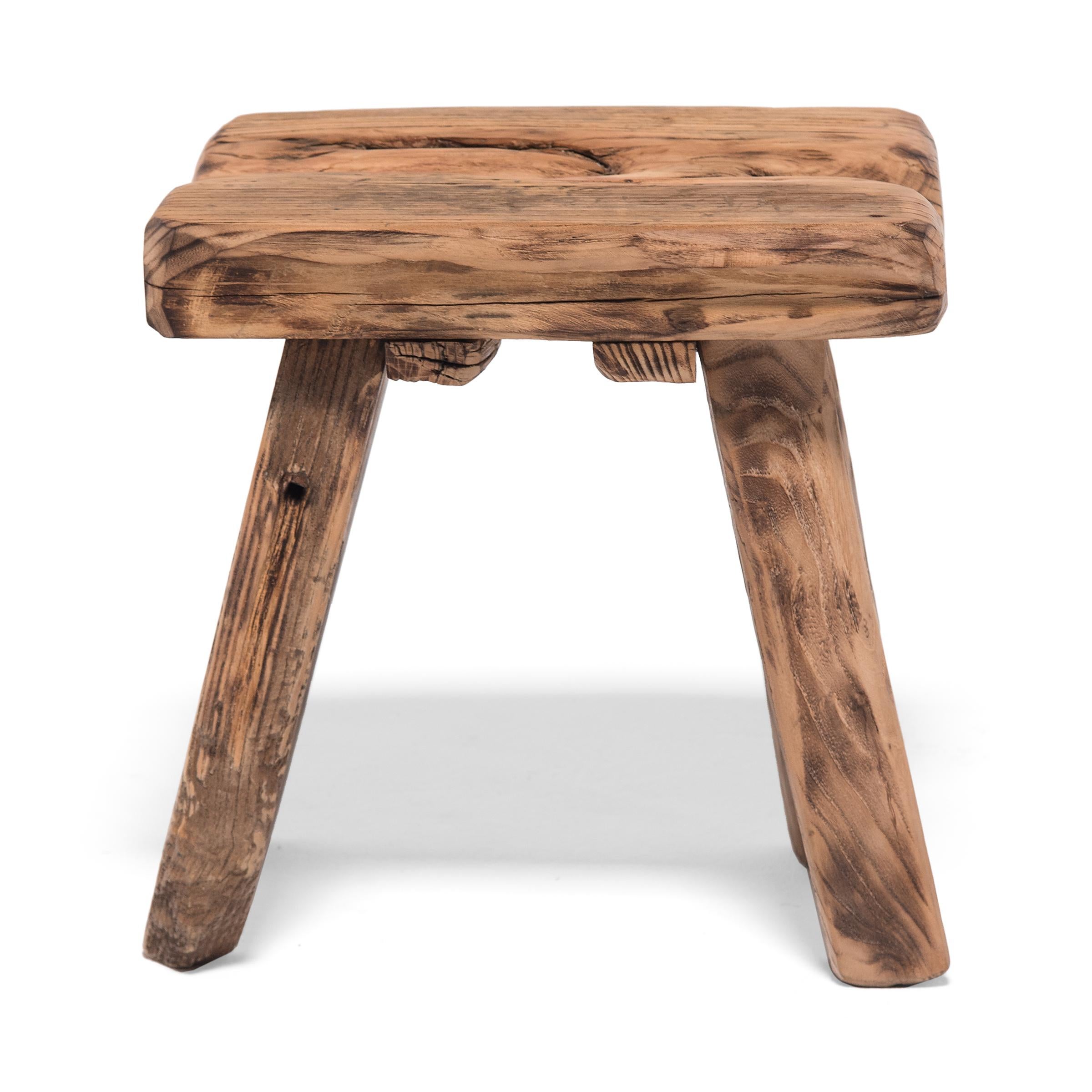 Crafted of wood reclaimed from 18th century Chinese buildings, this contemporary four-leg stool is the epitome of farmhouse modern. Embracing the notion of “wabi-sabi,” the little stool charms with its irregular edges and array of knots, splits, and
