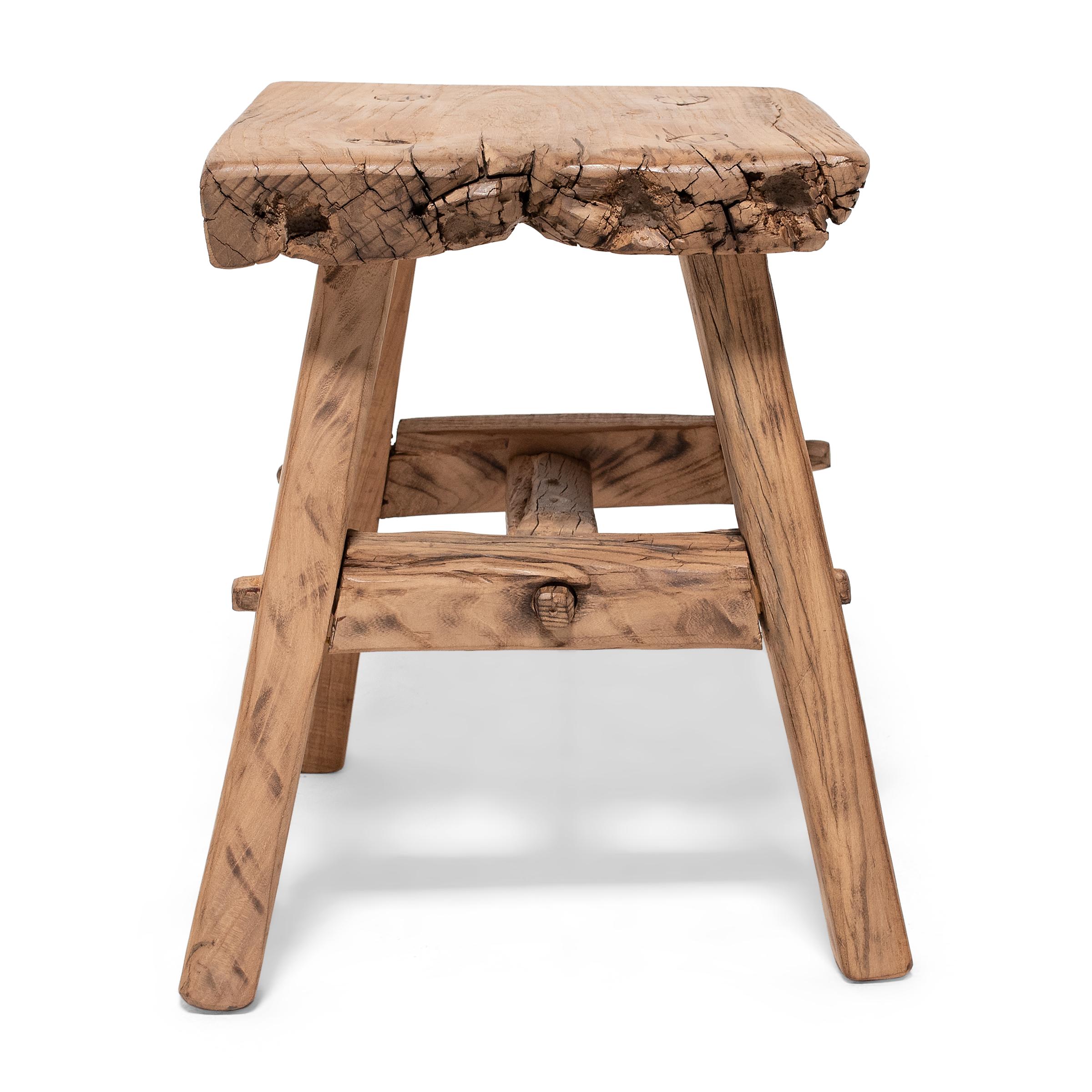 Crafted of wood reclaimed from 18th-century Chinese buildings, this square four-leg stool is the epitome of farmhouse modern. Embracing the notion of “wabi-sabi,” the little stool charms with its irregular edges and array of knots, splits, and nail