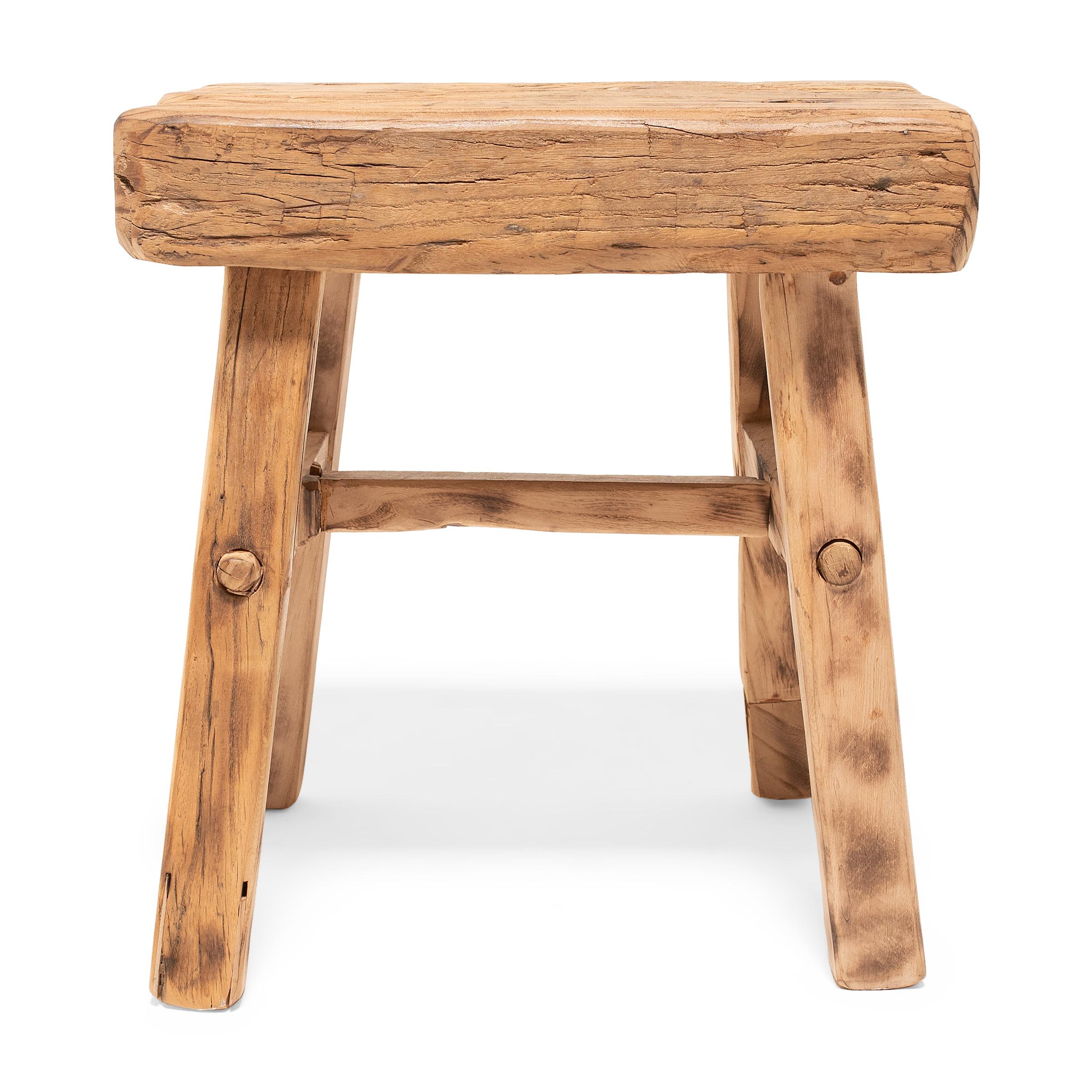 Crafted of wood reclaimed from 18th-century Chinese buildings, this contemporary four-leg square stool is the epitome of farmhouse modern. Embracing the notion of “wabi-sabi,” the low stool charms with irregular edges and an array of knots, splits,