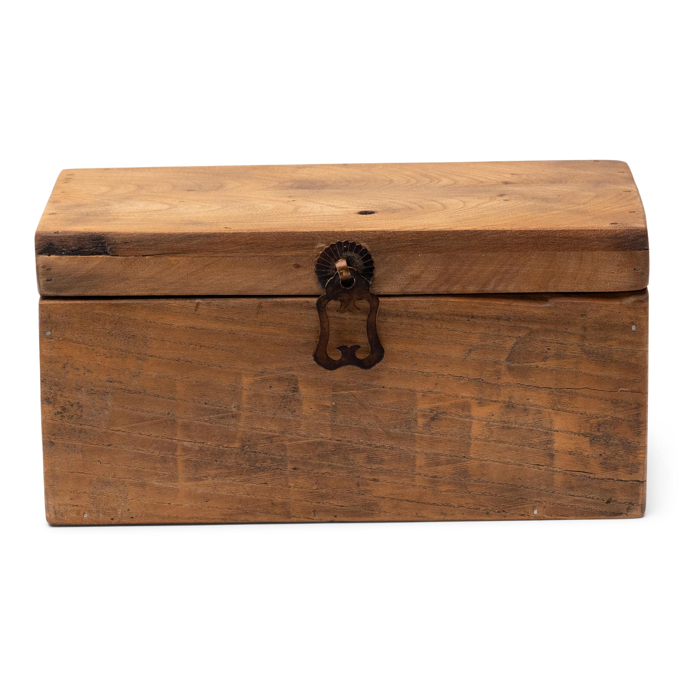 This rustic little box is crafted with repurposed wood boards with chiseled texture and golden brown color. Ideal for hiding household clutter, the wooden box has a rectangular form and is finished with a brass drop pull in the style of Chinese
