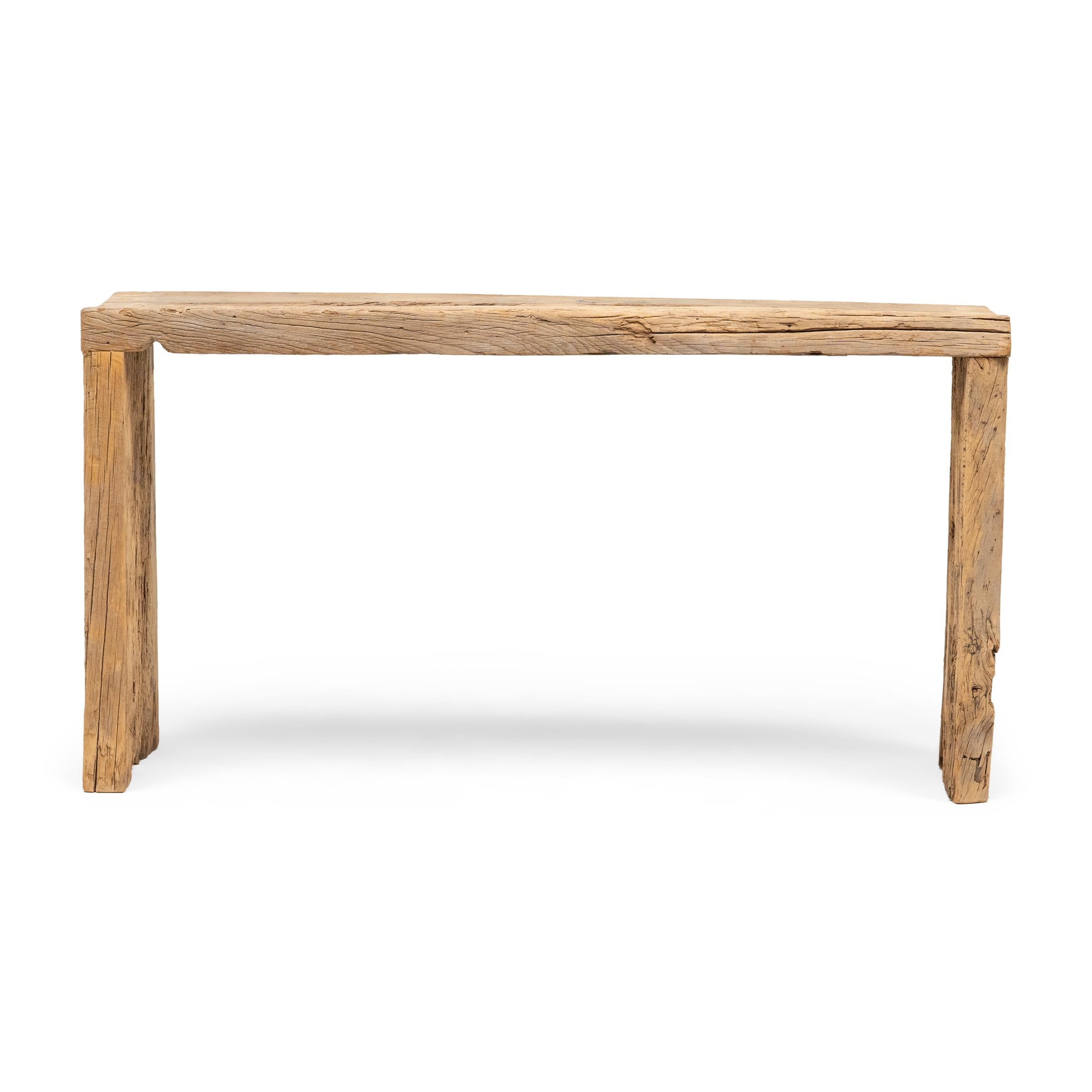 This contemporary console table is a celebration of wabi-sabi style. Crafted of wood reclaimed from Qing-dynasty architecture, the table has a minimalist waterfall design with dovetailed corners that recreate traditional joinery methods. The rustic