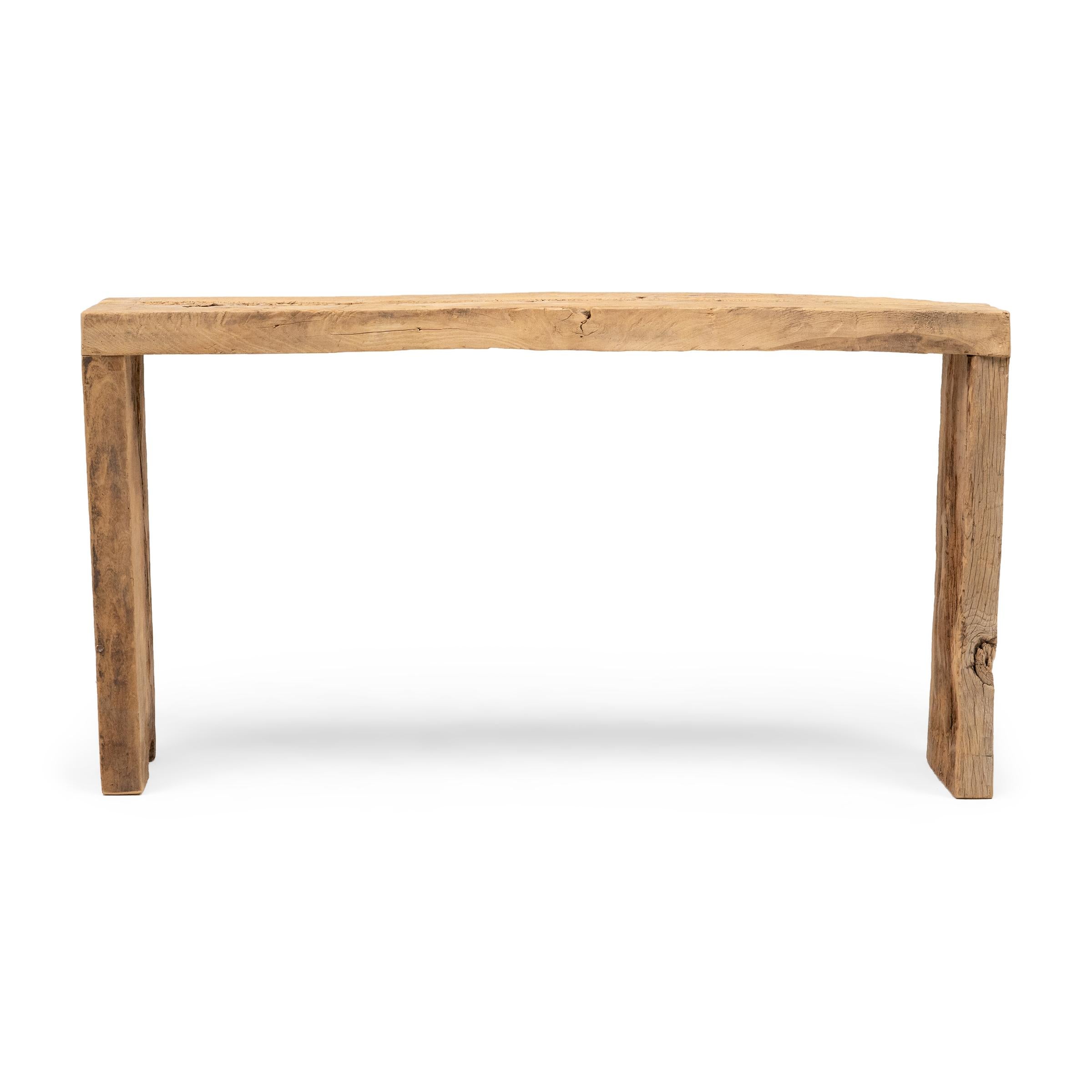 This contemporary console table is a celebration of wabi-sabi style. Crafted of wood reclaimed from Qing-dynasty architecture, the table has a minimalist waterfall design with dovetailed corners that recreate traditional joinery methods. The rustic