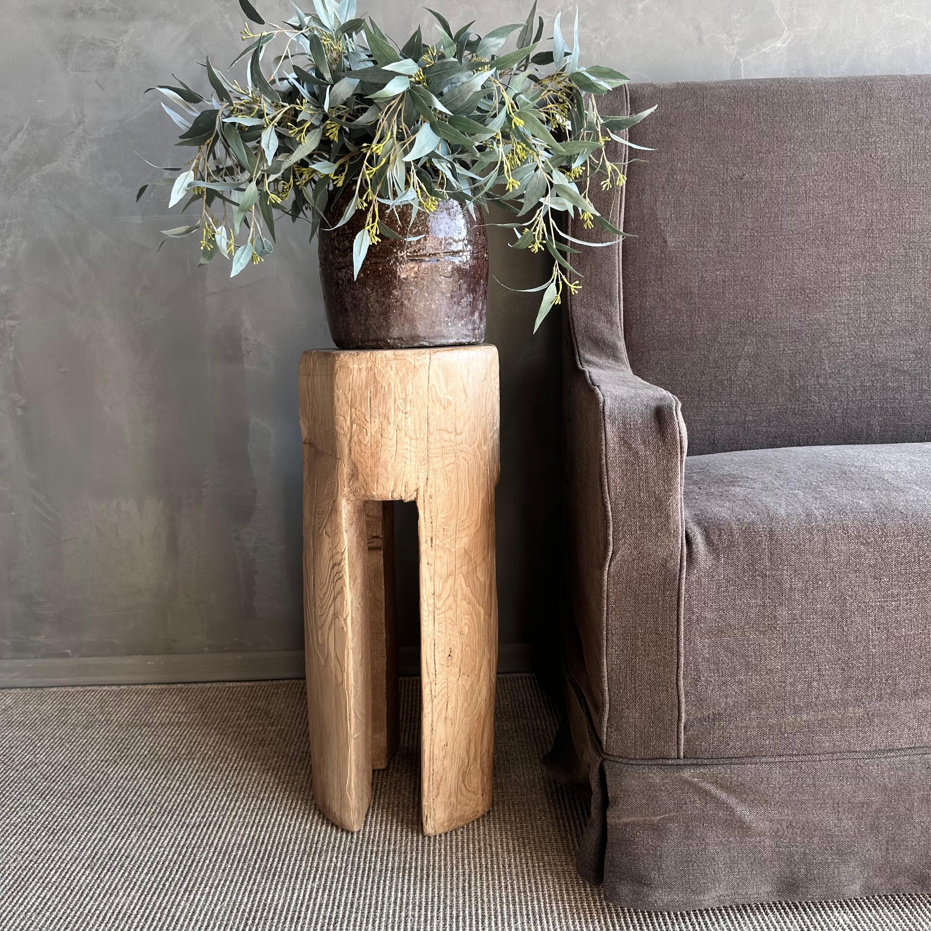 Crafted from reclaimed elm wood timbers, the Kona Side Table is an exquisite piece that emanates a natural and rustic charm. Carved from a solid stump, this table offers a reliable surface for holding drinks, decorative items, or serving as a stand.
