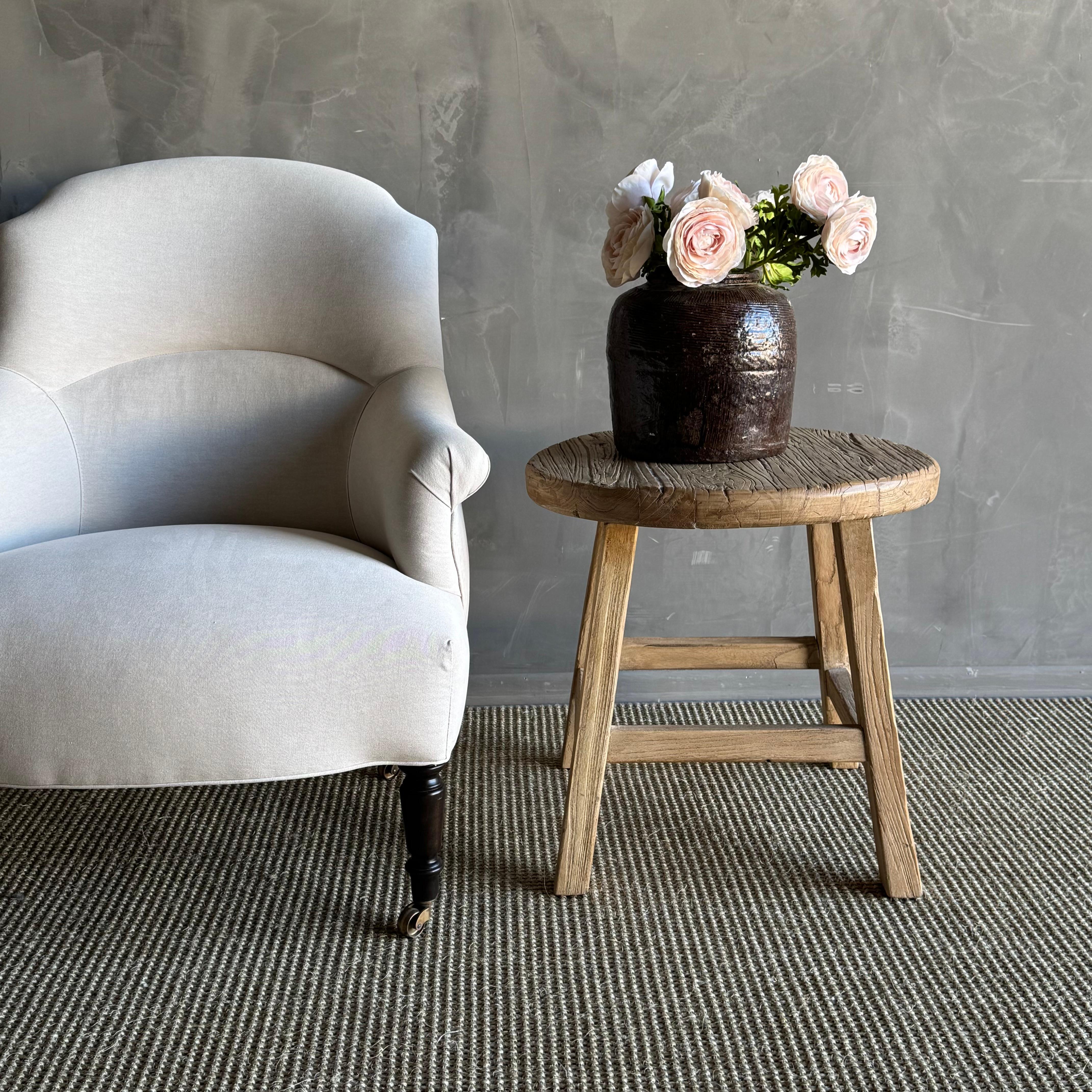 Introducing the Sara side table, crafted from solid reclaimed elm wood with a natural finish and wax coating. This unique piece adds a touch of wabi sabi charm to your home decor, bringing a sense of rustic beauty and simplicity. The natural