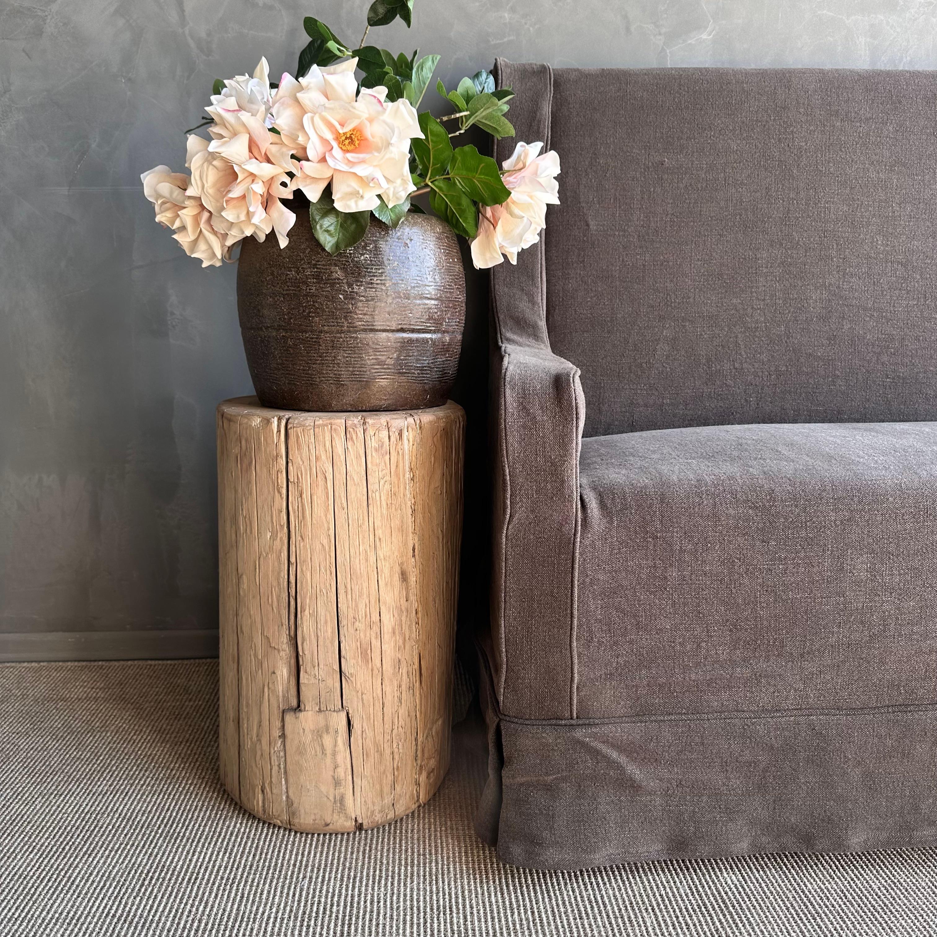 Introducing the raw reclaimed elm wood stump, a unique piece perfect for a side table. Crafted from reclaimed elm wood, this stump showcases natural cracks and fissures that add character and charm to any living space. Its wabi sabi look brings a