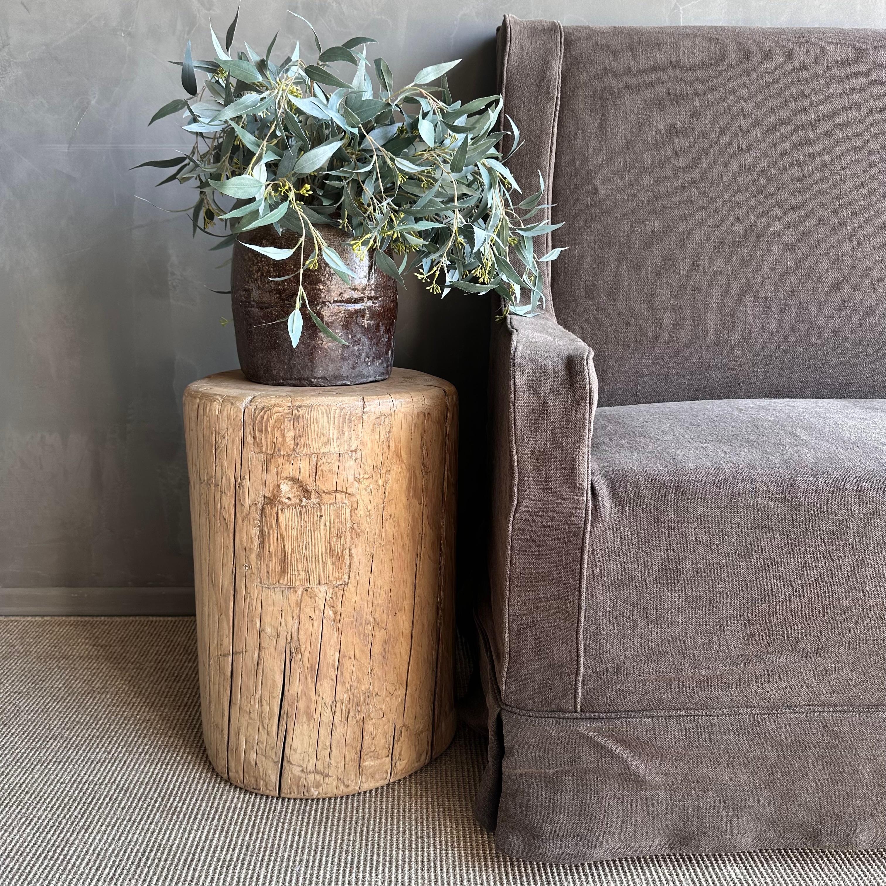 Introducing the raw reclaimed elm wood stump, a unique piece perfect for a side table. Crafted from reclaimed elm wood, this stump showcases natural cracks and fissures that add character and charm to any living space. Its wabi sabi look brings a