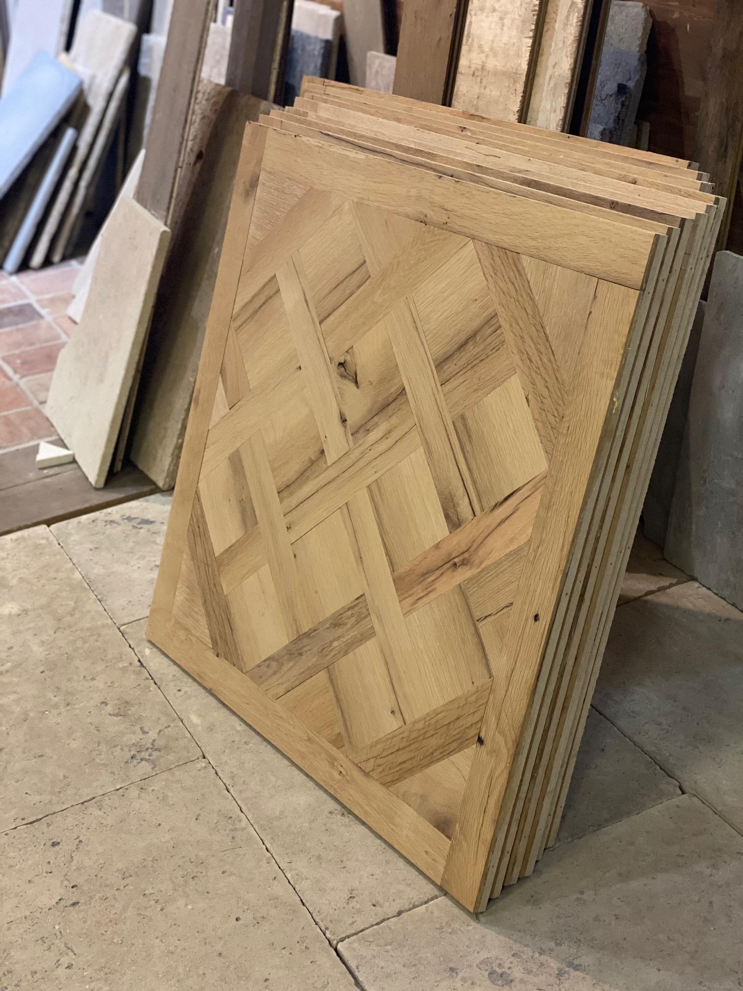 Antique oak flooring in a versailles pattern, the oak dates back to the 1800s. 

Each 1-meter square is handmade to order at any square footage needed. There are a number of different finish option available but the standard to order is in the raw