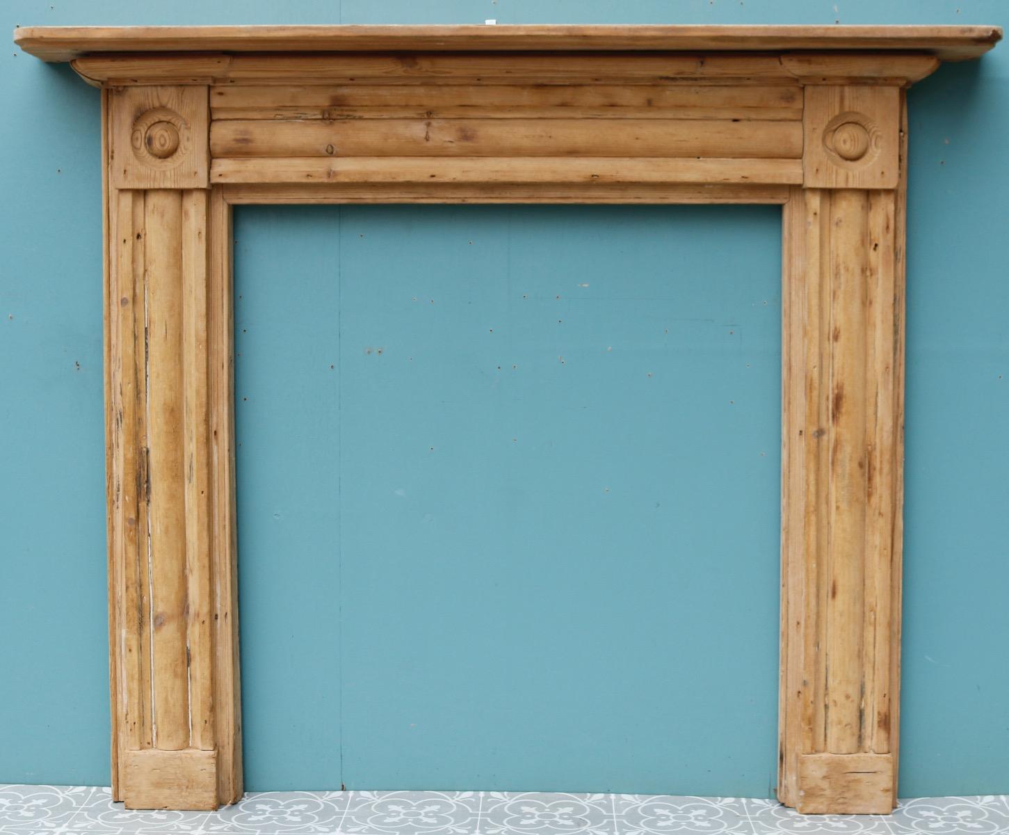 A Georgian period fire surround with carved ‘bullseye’ end blocks.

Additional dimensions 

Opening height 90.5 cm

Opening width 82.5 cm.

Width between outsides of the foot blocks 121 cm.