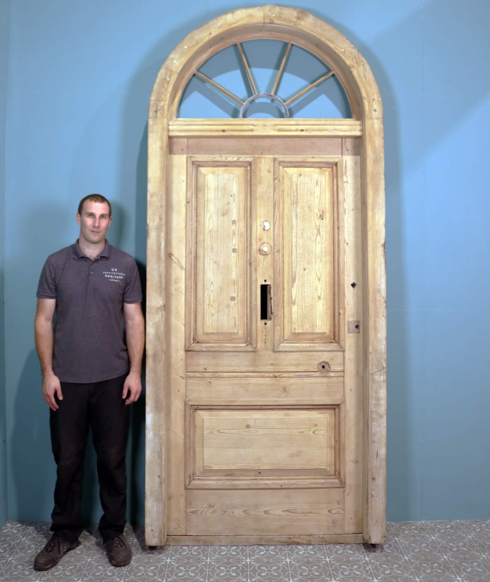 Dating from the late 1800s, this pine front door with fanlight is an excellent example of Georgian architectural style. The arched fanlight top is distinctive of the period, the pine frame and zinc semi-circle once glazed to allow light to cast into