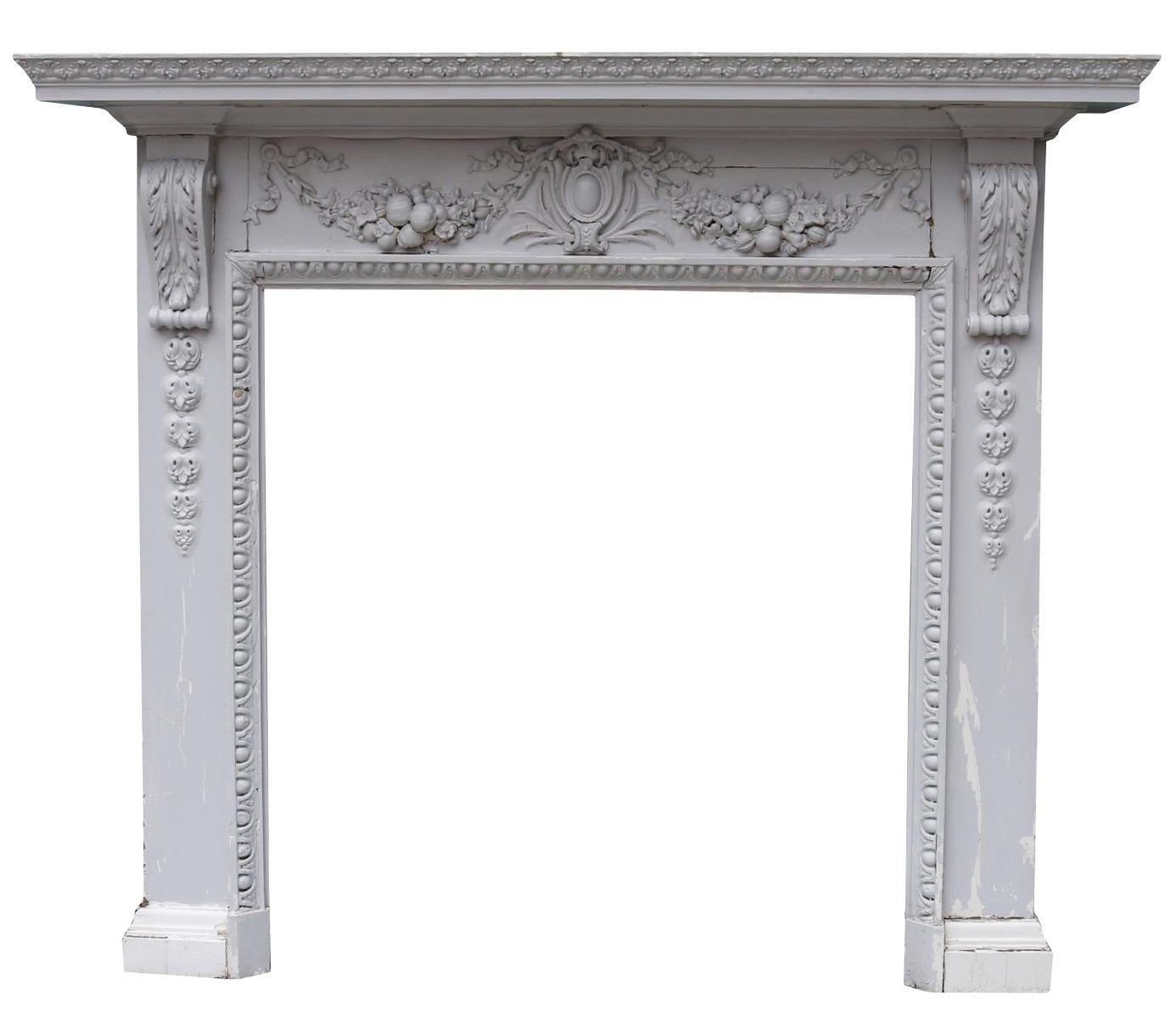 An antique Neoclassical style fireplace surround constructed from pine, with applied composition decoration, painted.

Additional dimensions:

Opening height 109.5 cm

Opening width 101.5 cm

Width between outsides of the foot blocks 148 cm.