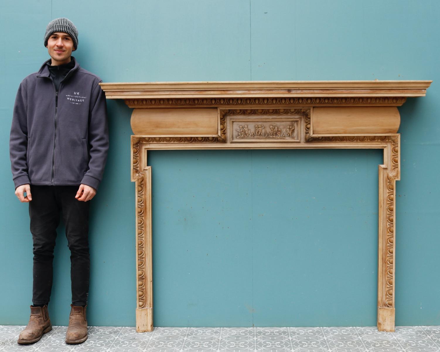 A large reclaimed Georgian style pine and composition fire surround. The central frieze depicting Putti.

Additional Dimensions 

Opening Height 108 cm

Opening Width 139.5 cm to 134 cm

Width between outsides of the foot blocks 153 cm.
