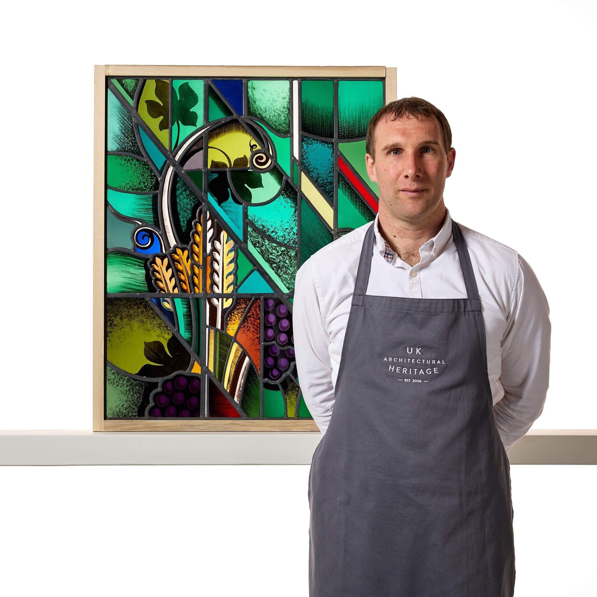 A reclaimed stained glass window of fruit and foliage within an abstract scene by Goddard and Gibbs.

This is an abstract modernist stained glass window with an unusual design, blending together a range of vibrant colours, shapes and patterns, such