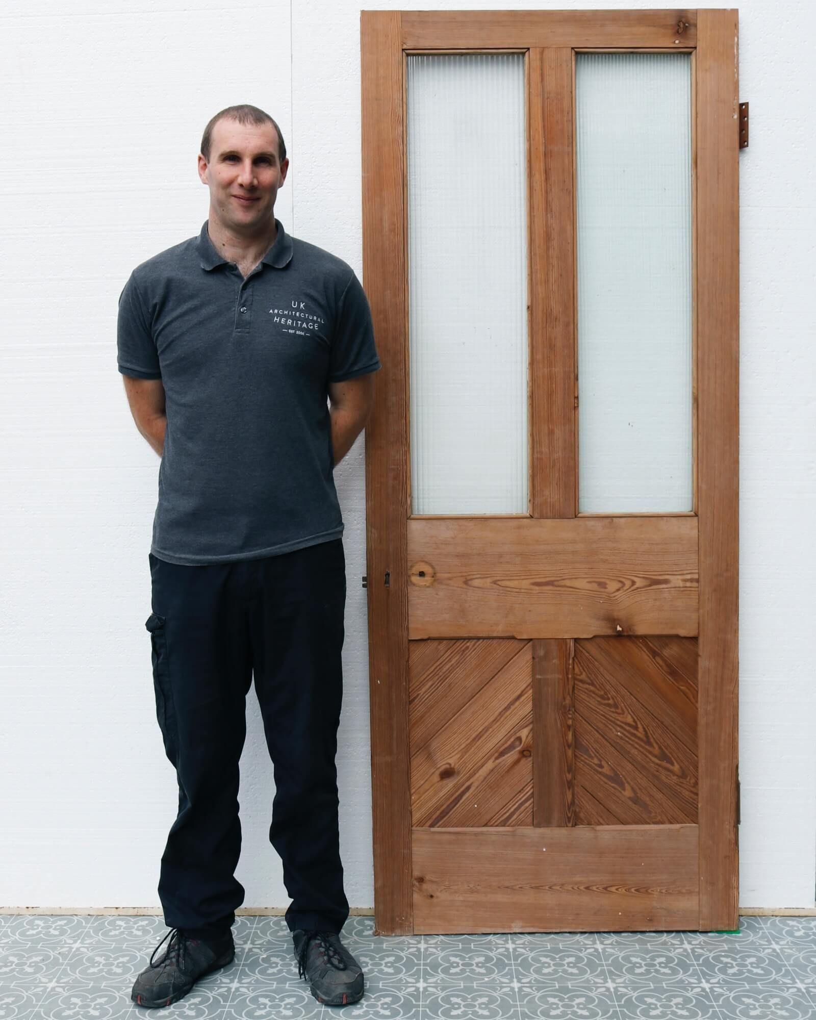 A smart and sturdy reclaimed half glazed pitch pine internal door dating from the late 19th century. This door has been dipped, giving it an appealing warm wood colour, and half glazed with reeded glass, making it an ideal reclaimed door for a