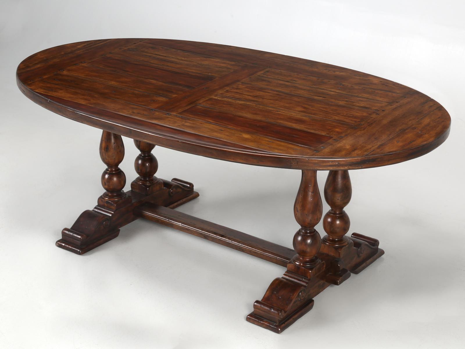 Reproduction oval farm house style dining table made from reclaimed hardwood. A great chunky rustic look for not much dough. Fantastic in a wine cellar.