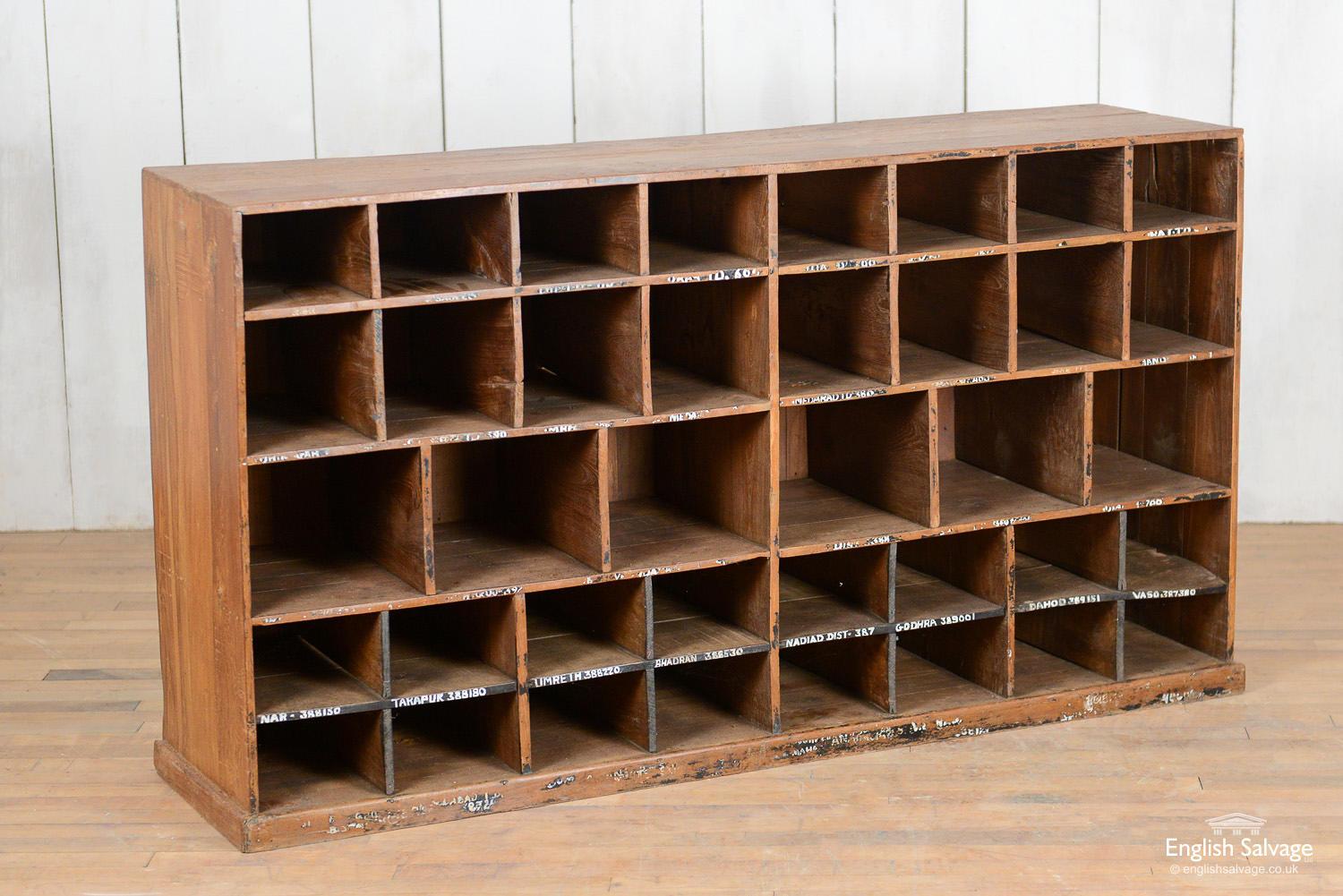 Rustic wooden pigeon hole unit reclaimed from India. This piece of furniture provides useful storage with 38 pigeon holes, most of which have Indian place names hand written below. A few water marks, wear and tear present.