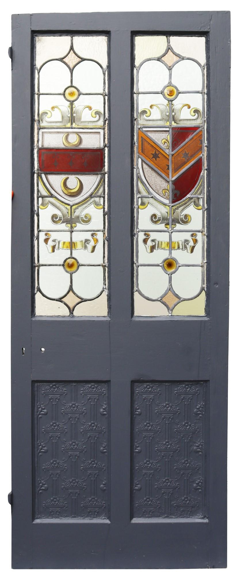 A painted pine door with impressive stained glass panels, suitable for interior use.

Patterned, embossed lower panels to the front, plain on reverse.

All stained glass is complete, without breaks.