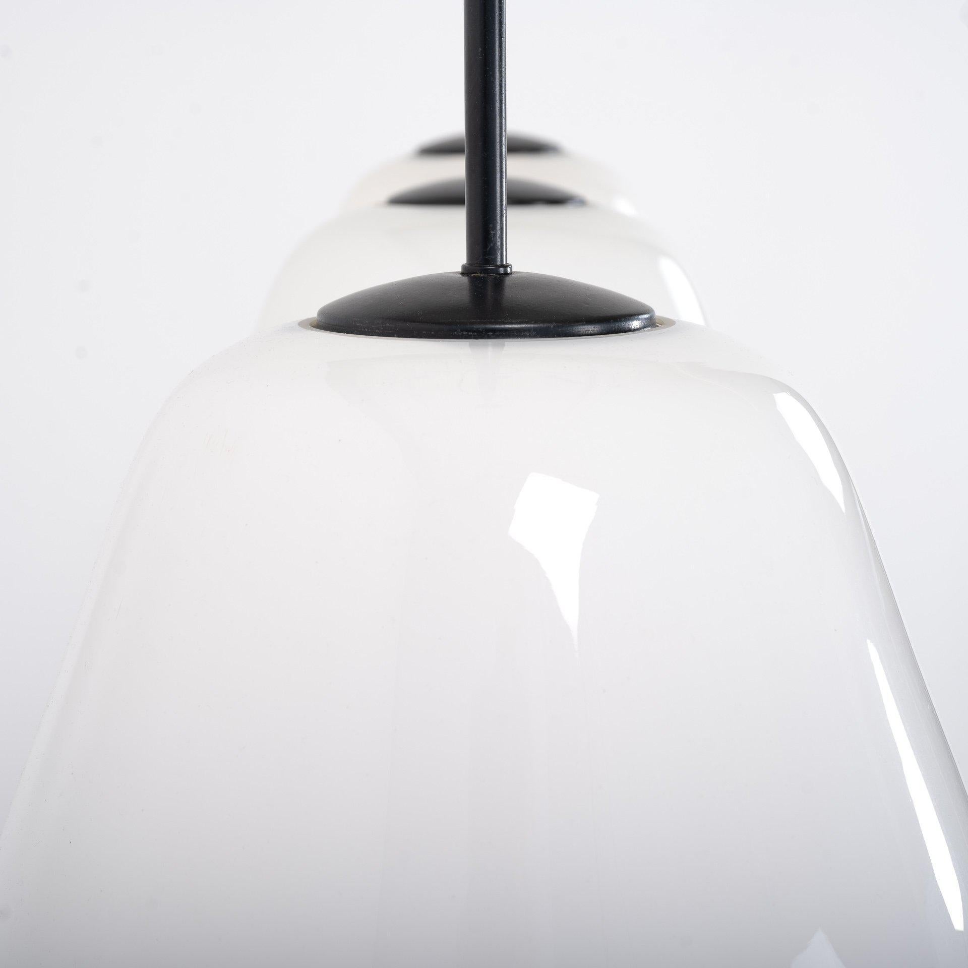 Vintage British school opaline glass trapezoid pendant lights.
An amazing run of antique opaline trapezoid pendant lights, salvaged from an all-girls grammar school in Manchester.

English made circa 1940 by Falk, Stadelmann and Co. Ltd

These