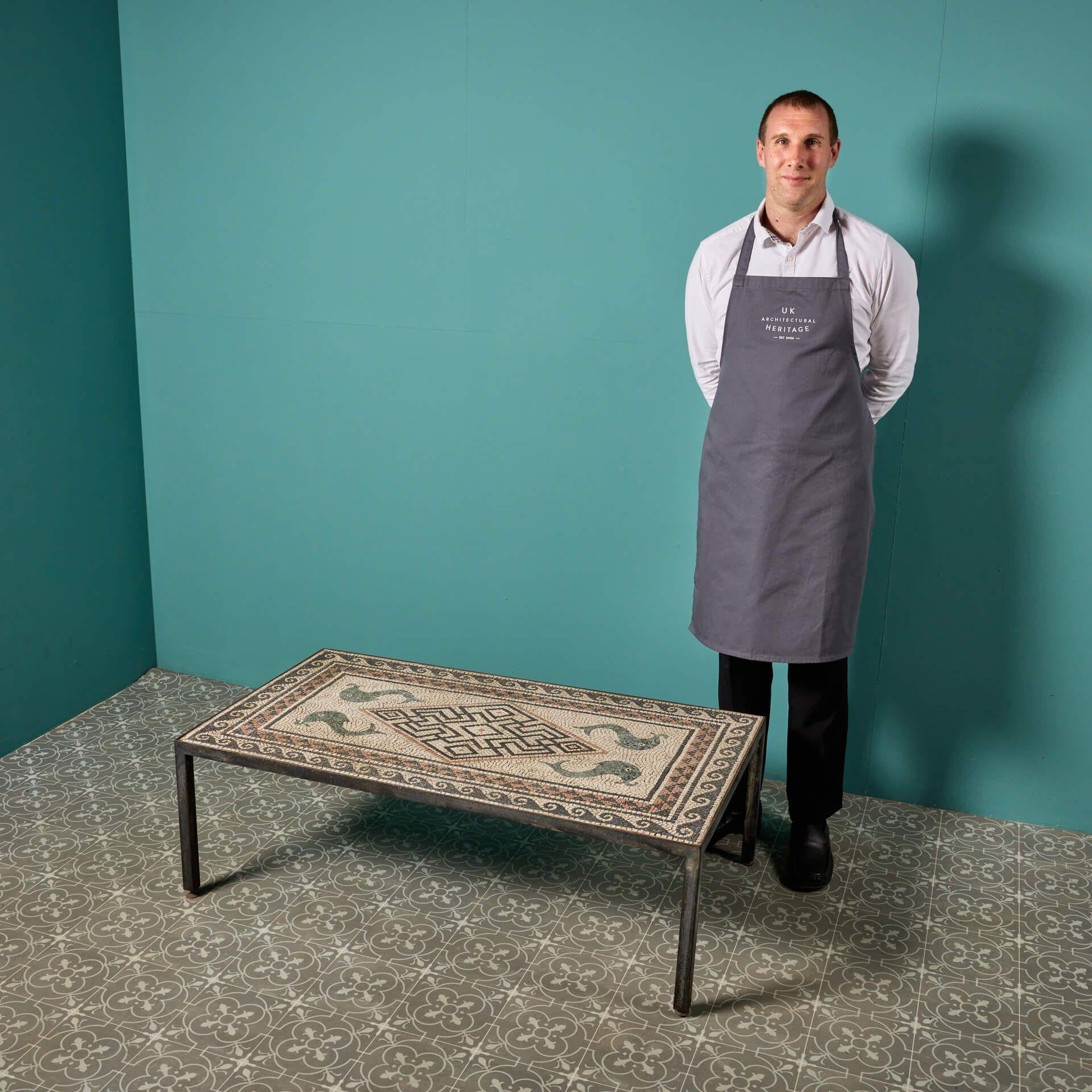 A reclaimed mosaic coffee or garden table by Vestey Entwistle after a Roman mosaic floor seen in the ancient Rome temple Maison Carrée, Nîmes.

This table is nicely weathered and decorated with a neoclassical style pattern, suitable for interior or