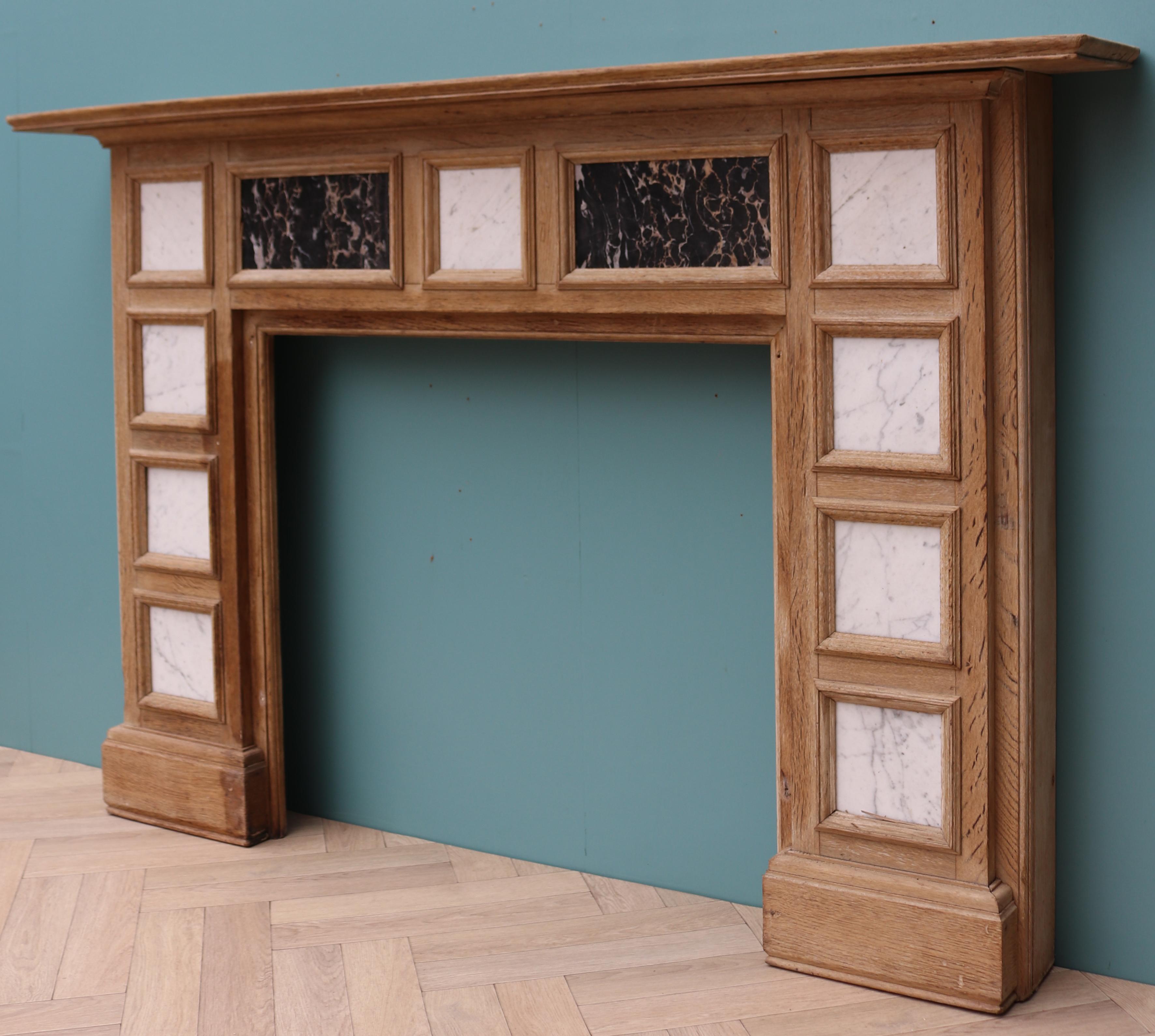 A reclaimed oak fire surround inset with white Carrara and black and gold Portoro marble panels.

Additional Dimensions:

Opening Height 79.5 cm

Opening Width 86.5 cm

Width between outside of foot blocks 154 cm.