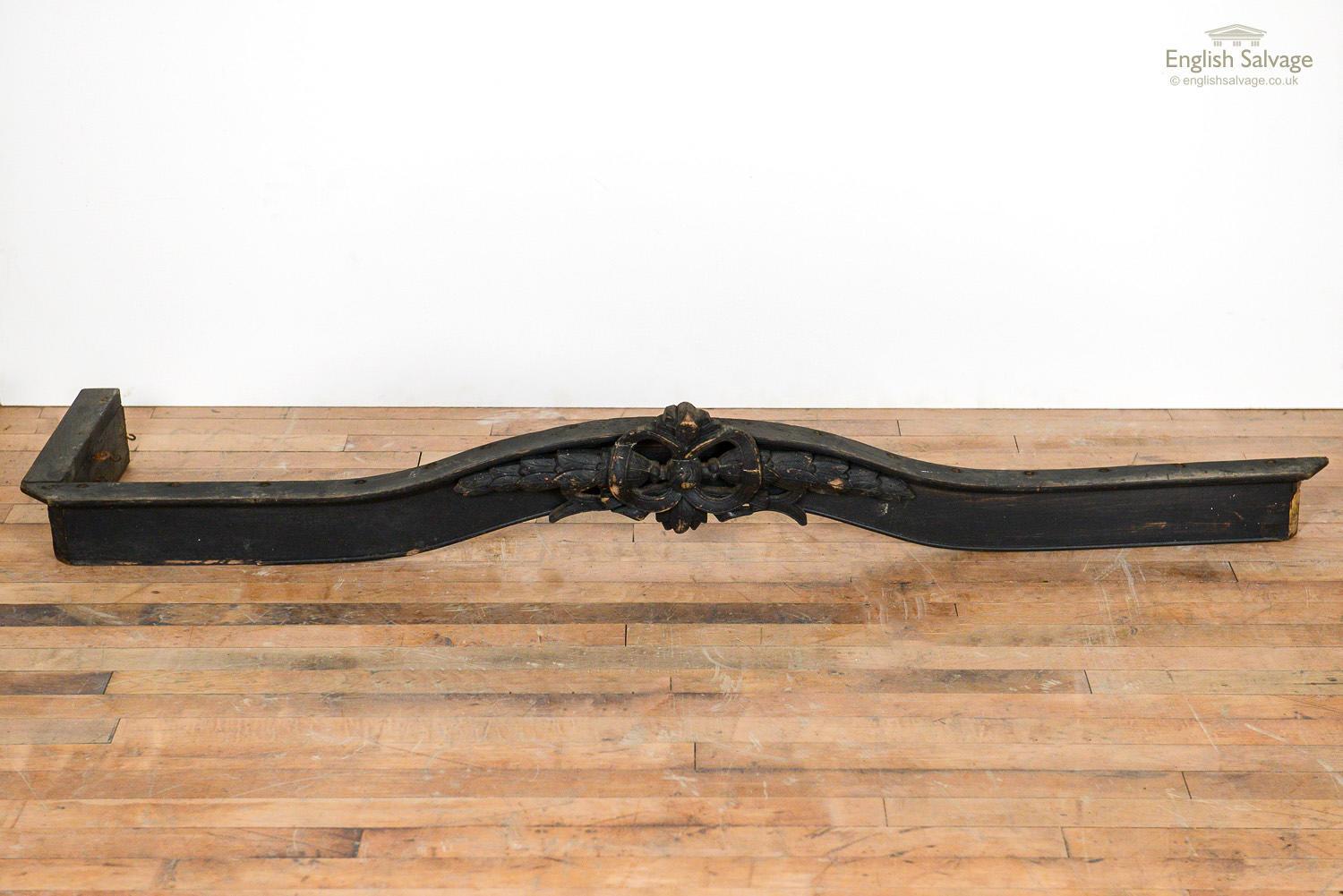 Old wooden pelmet with ribbon and foliate carving. Painted black. Old worm, missing return and repair to the front detail is reflected in the price.