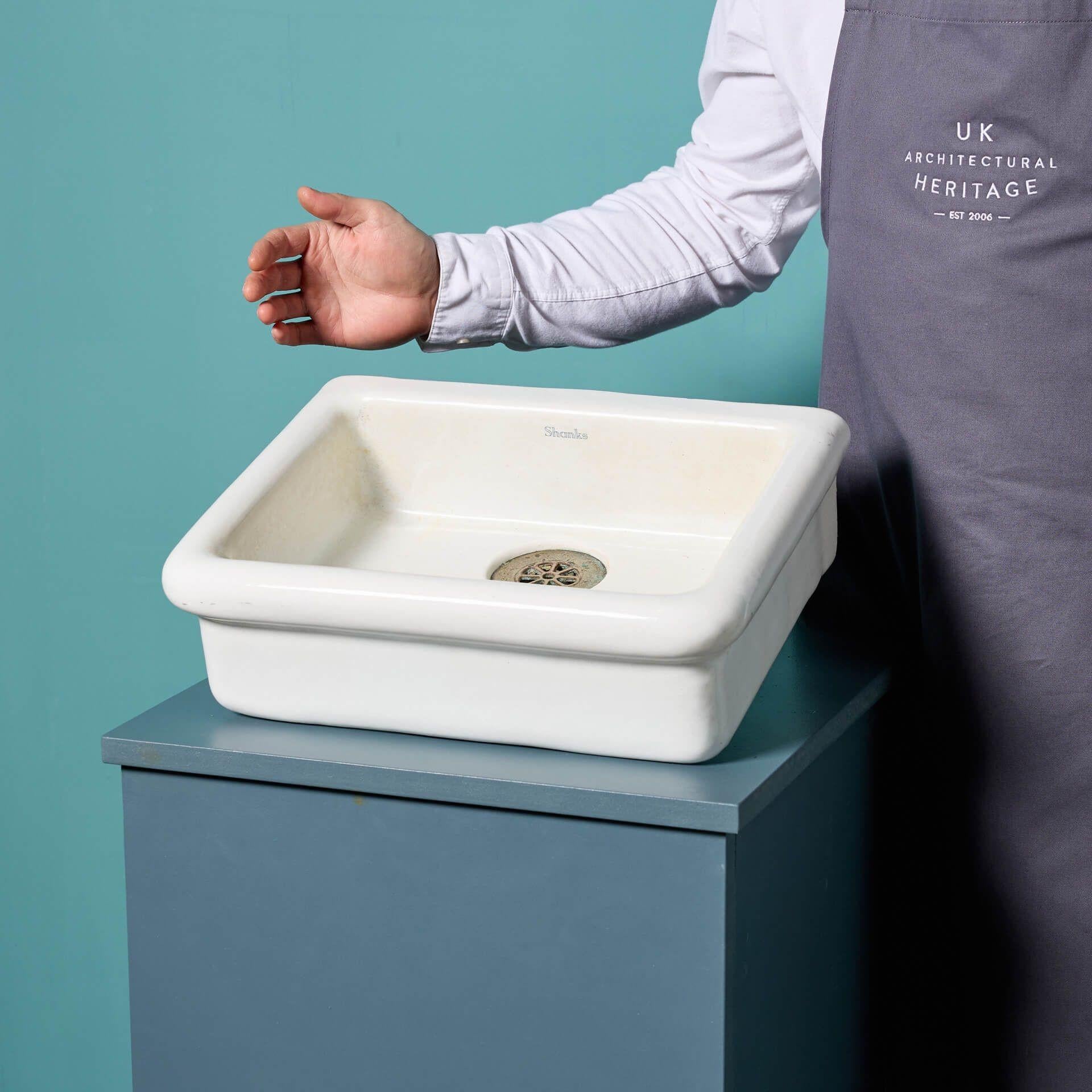 A reclaimed petite Shanks Belfast basin dating to circa 1920. With a wonderfully shaped rim, this unusually sized sink could be flush mounted into a counter top or supported on brackets. Its desirable shallow basin is suitable for period and modern