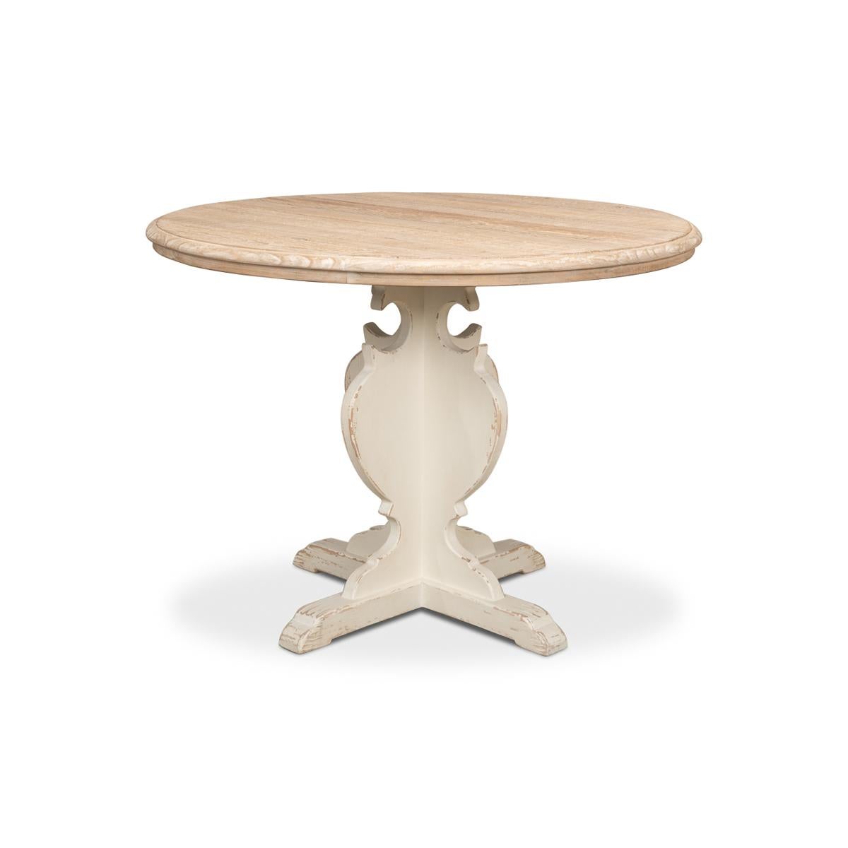 Introducing our reclaimed pine French Bistro table, the perfect addition to any dining space. The round pine wood top is finished in a natural tone, giving it a warm and inviting feel, while the antiqued and distressed white-painted pedestal base
