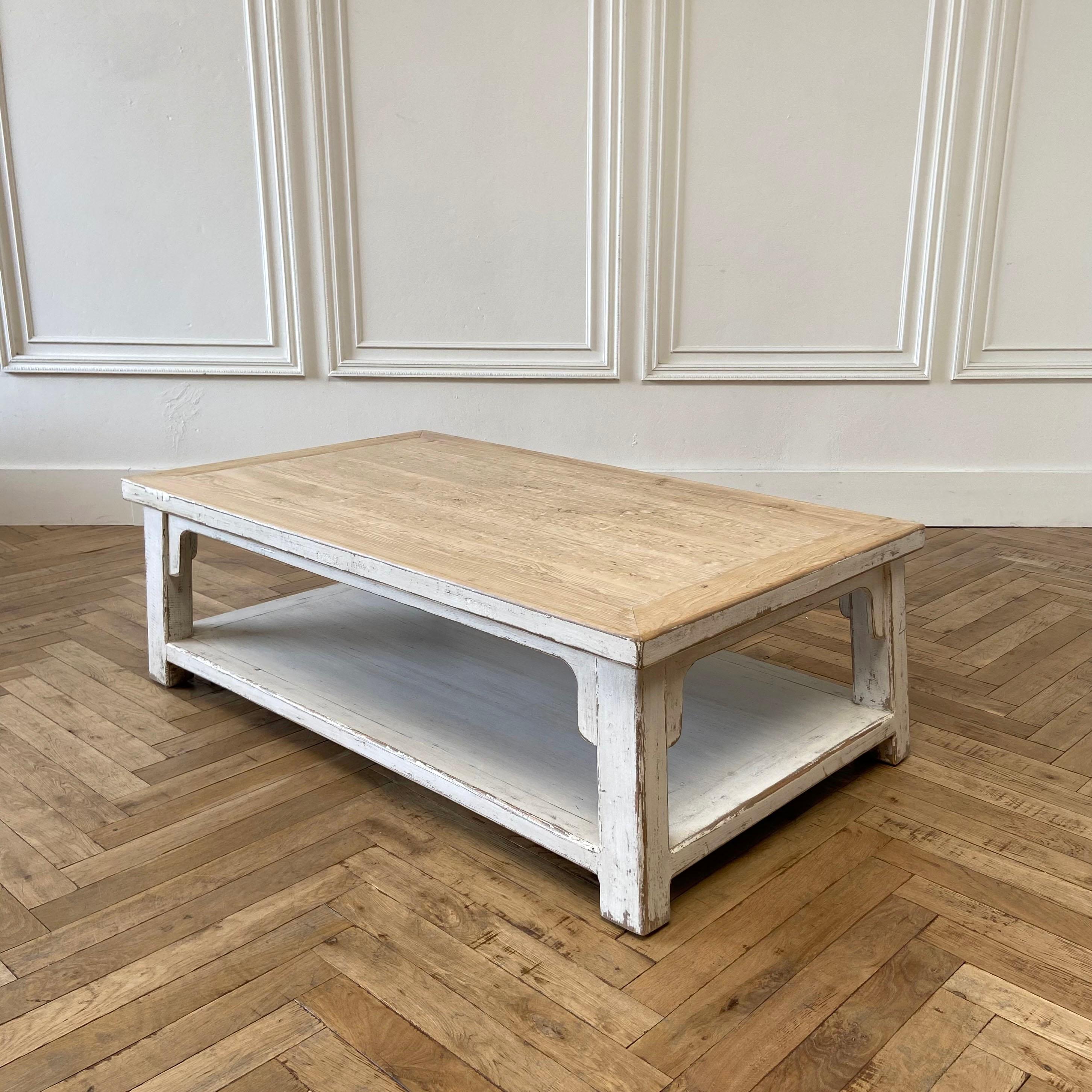 Reclaimed pine oversized coffee table with white painted legs. Coffee table has an open shelf, painted distressed white legs. The table top is natural with a hand scraped top.
Size: 55”W x 32”D x 17.5