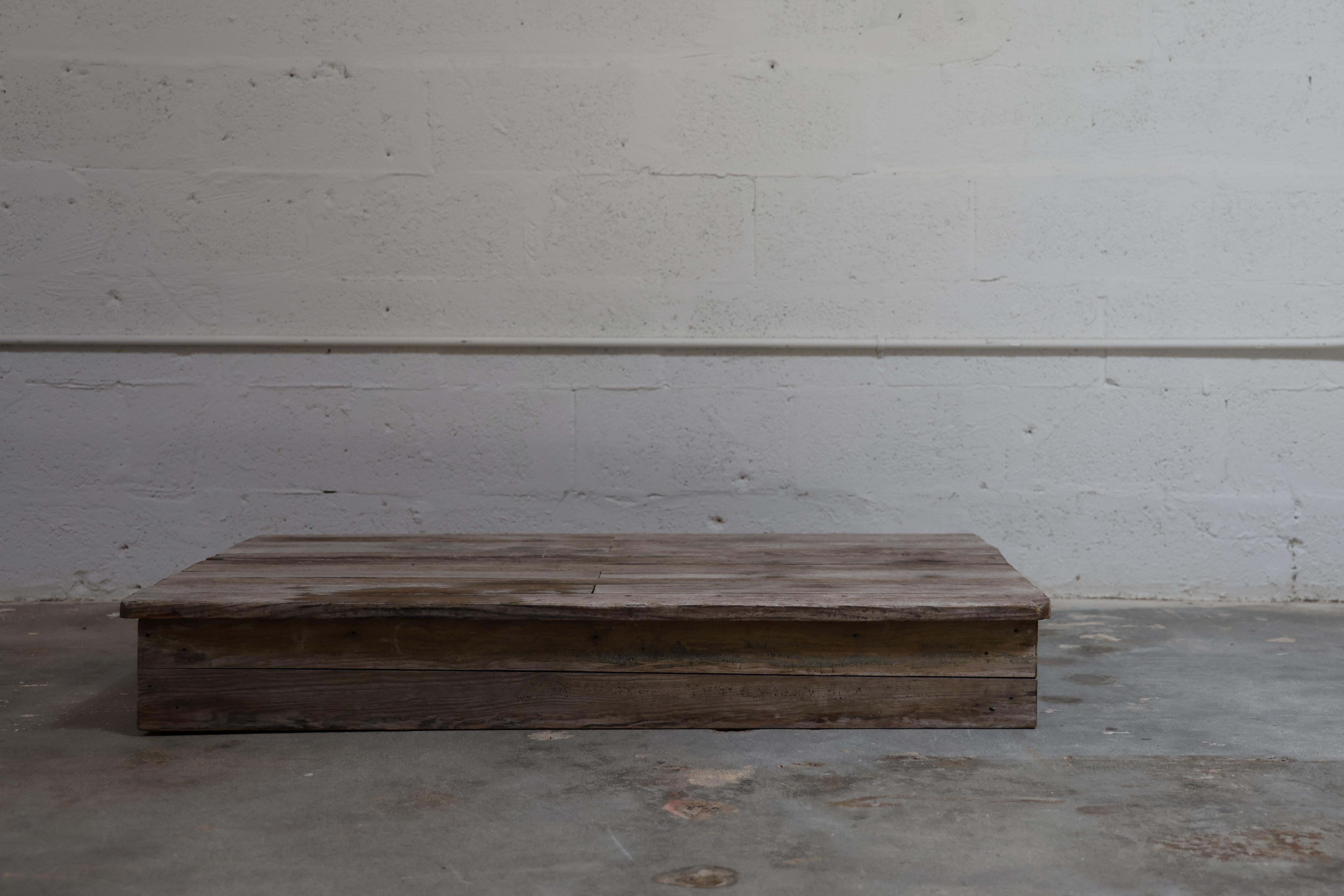 Crafted from salvaged wood with a timeworn patina, this low-profile coffee table embodies raw simplicity and understated presence. Its plank-style top highlights the natural grain, knots, and imperfections that give reclaimed timber its