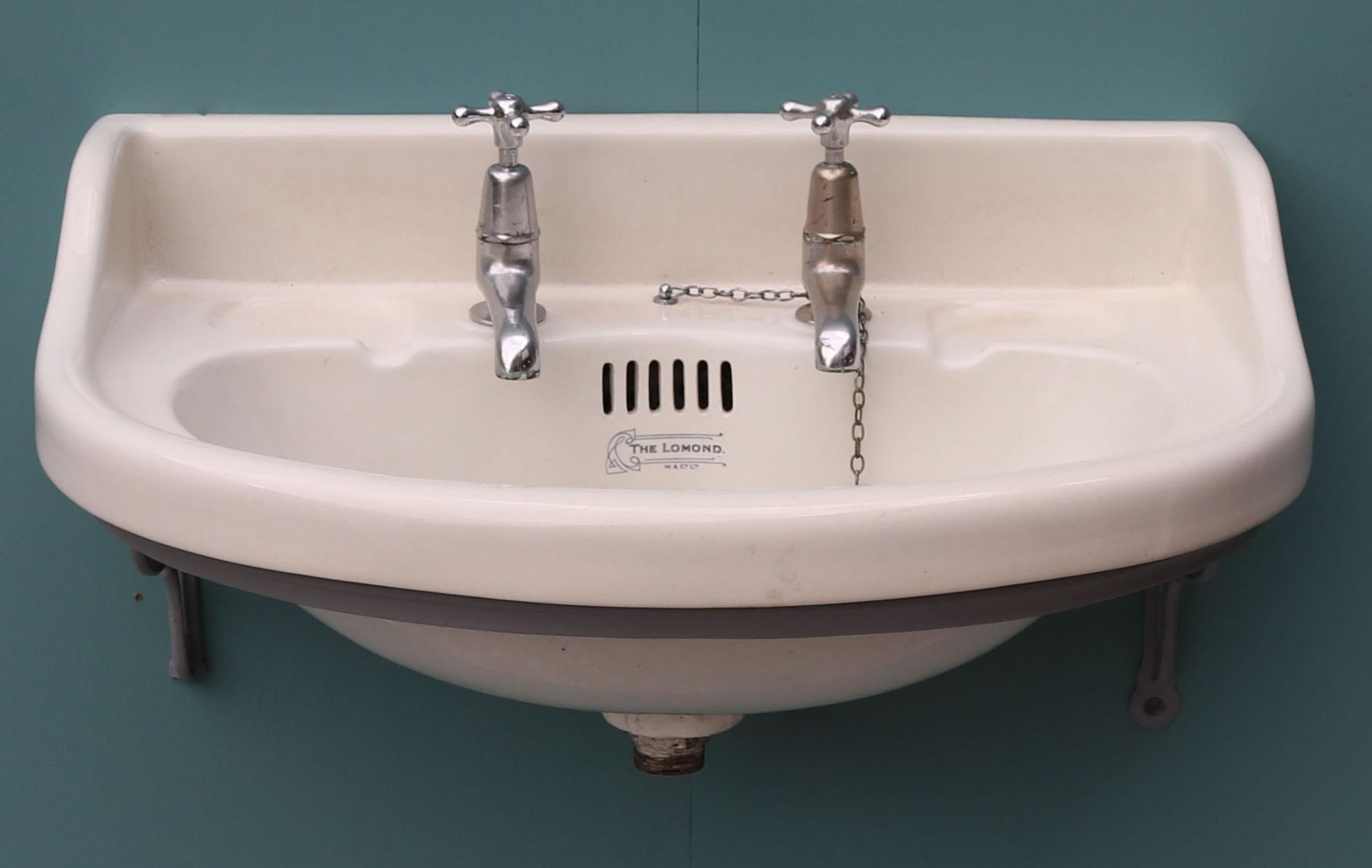 About:

A reclaimed Victorian / Edwardian style bow fronted basin. Stamped ‘The Lomond’ by W & Co Ltd. 

Condition report:

This sink has no cracks or breaks however there is some light surface crazing and discolouration. The taps are