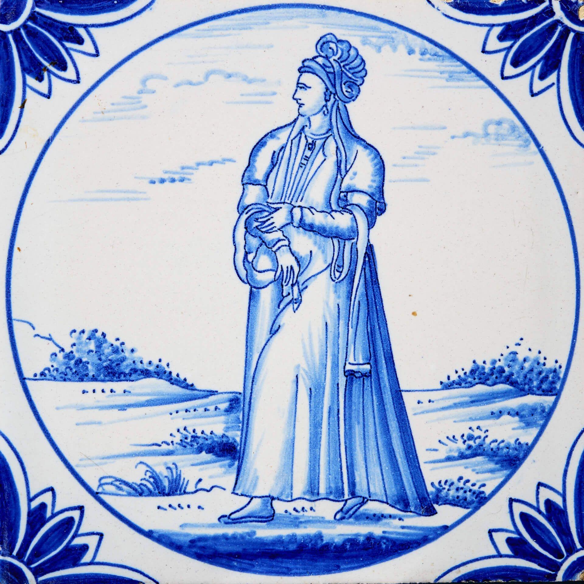 A reclaimed 19th century Delft tile of a woman in Turkish dress manufactured by Ravesteijn of Utrecht after an original 16th century drawing titled 'A Persian Lady' by French geographer, Nicolas De Nicolay (1517-1583).

This antique 6-inch tile