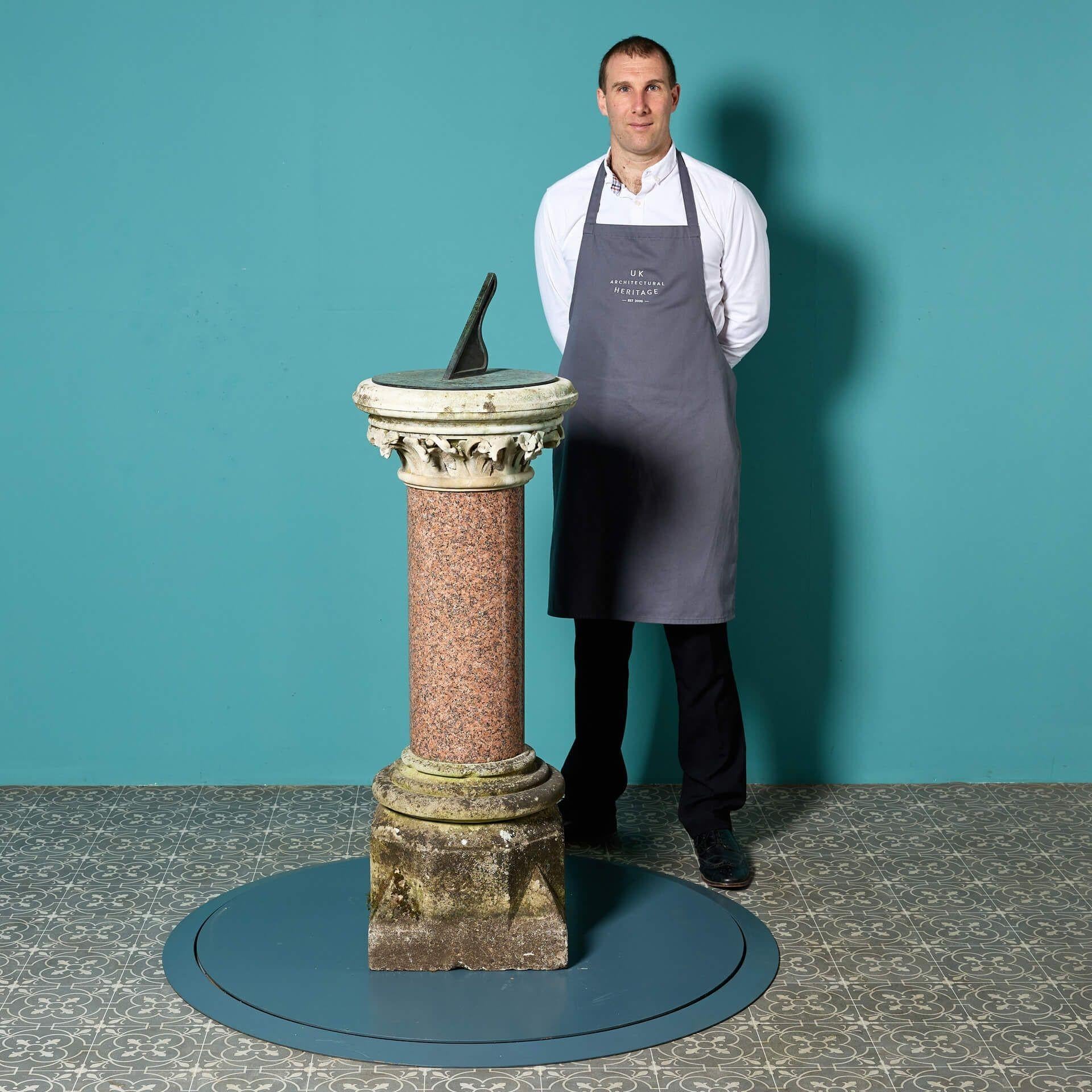 A striking reclaimed Scottish red granite sundial pedestal topped with a bronze dial plate by Negretti and Zambra, circa 1880. This antique sundial is heavy and substantial, the red granite column topped with an ornately carved limestone capital