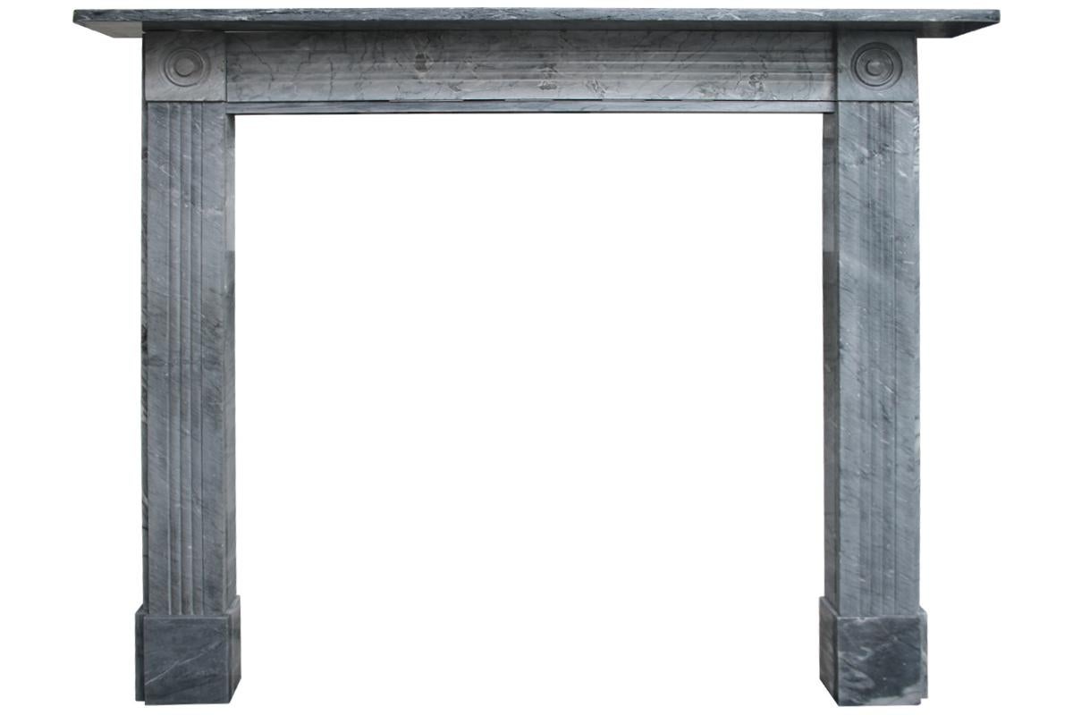 Small and elegant reclaimed Regency bullseye fireplace surround with fluted frieze and jambs, circa 1830.
Repair to left hand jamb. For details sizes see images.
Pictured with an original Georgian cast iron hob grate, sold separately.