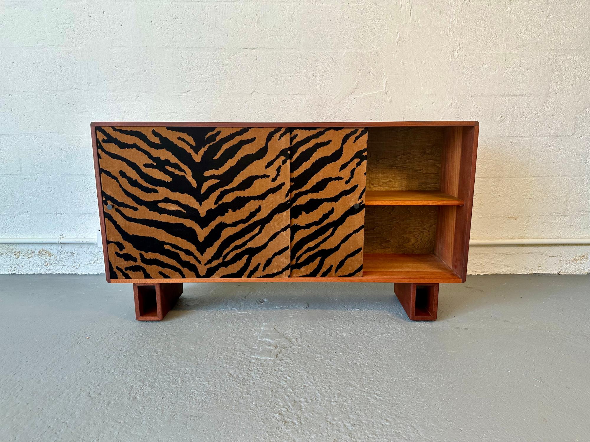 Rafael designed and handcrafted the exquisite Velvet Dresser from reclaimed solid Mahogany and an exotic animal print fabric. It is finished with a non-toxic oil accentuating the wood's natural grain. It has two sliding doors covered in a beautiful