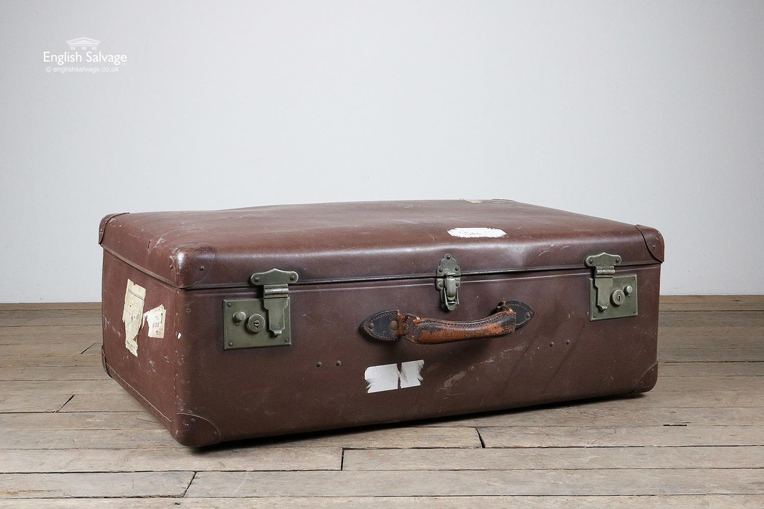 Vintage leather-look suitcase in a dark reddish brown colour. Leather handle with brass locks and closer. Signs of wear, few scuffs and remnants of old labels. Fabric lined, this is marked in places but in fair condition.
