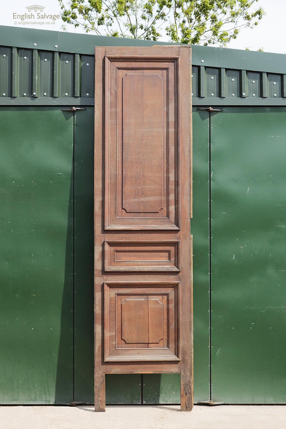 Tall oak door from France with three raised panels to the face and a plain back. Kick plate is missing and the panels are made from planks. Few dings and scuffs to edges.