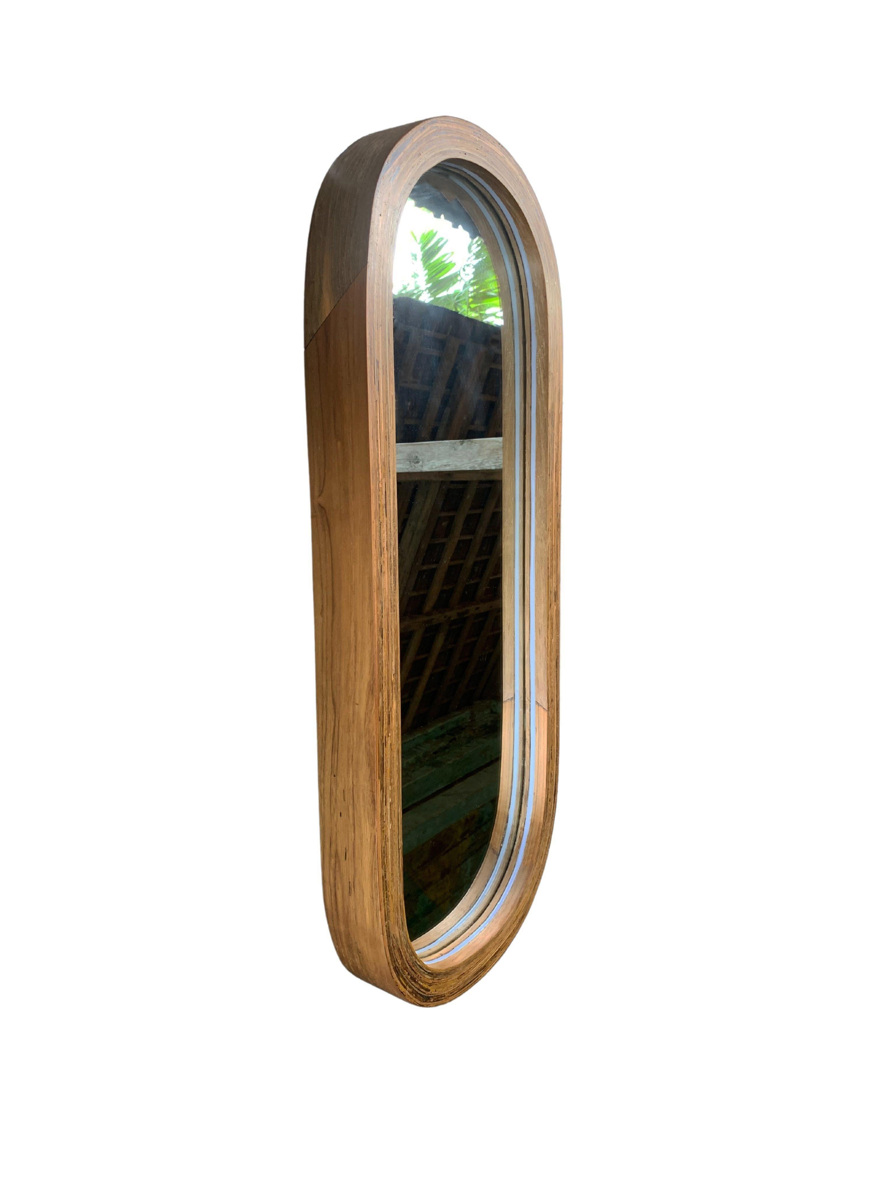 This mirror features a stunning reclaimed teak wood frame & polished finish. With wood sourced from old colonial houses in Indonesia. The wood texture adds to its charm. It features a plug in LED light rim. A wonderful modern organic object to bring
