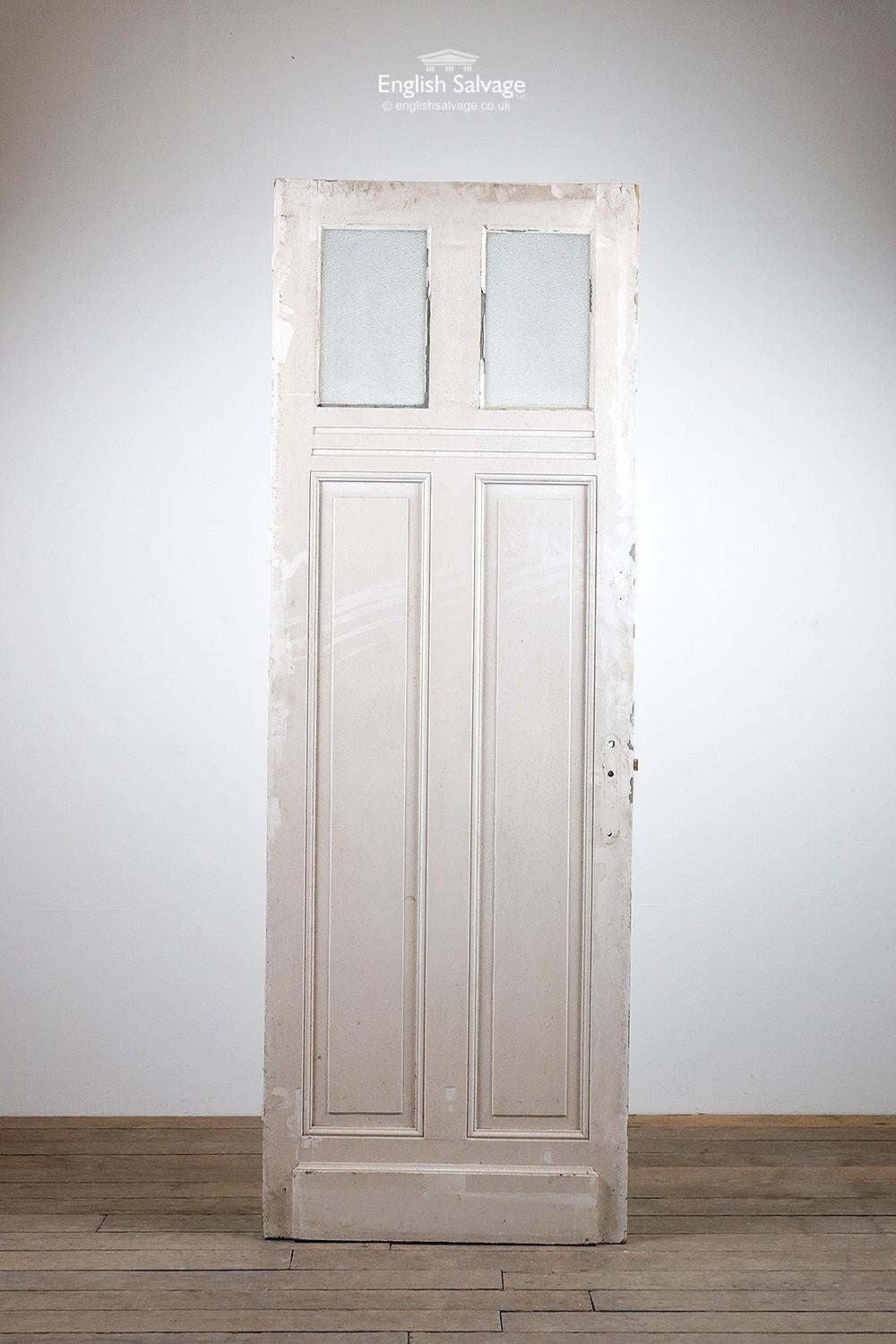 Salvaged tall glazed door from France, one of several we have in stock from the same property. Painted white both sides, dimpled glass to the upper panels. Kickplates to base. Old fitting holes.