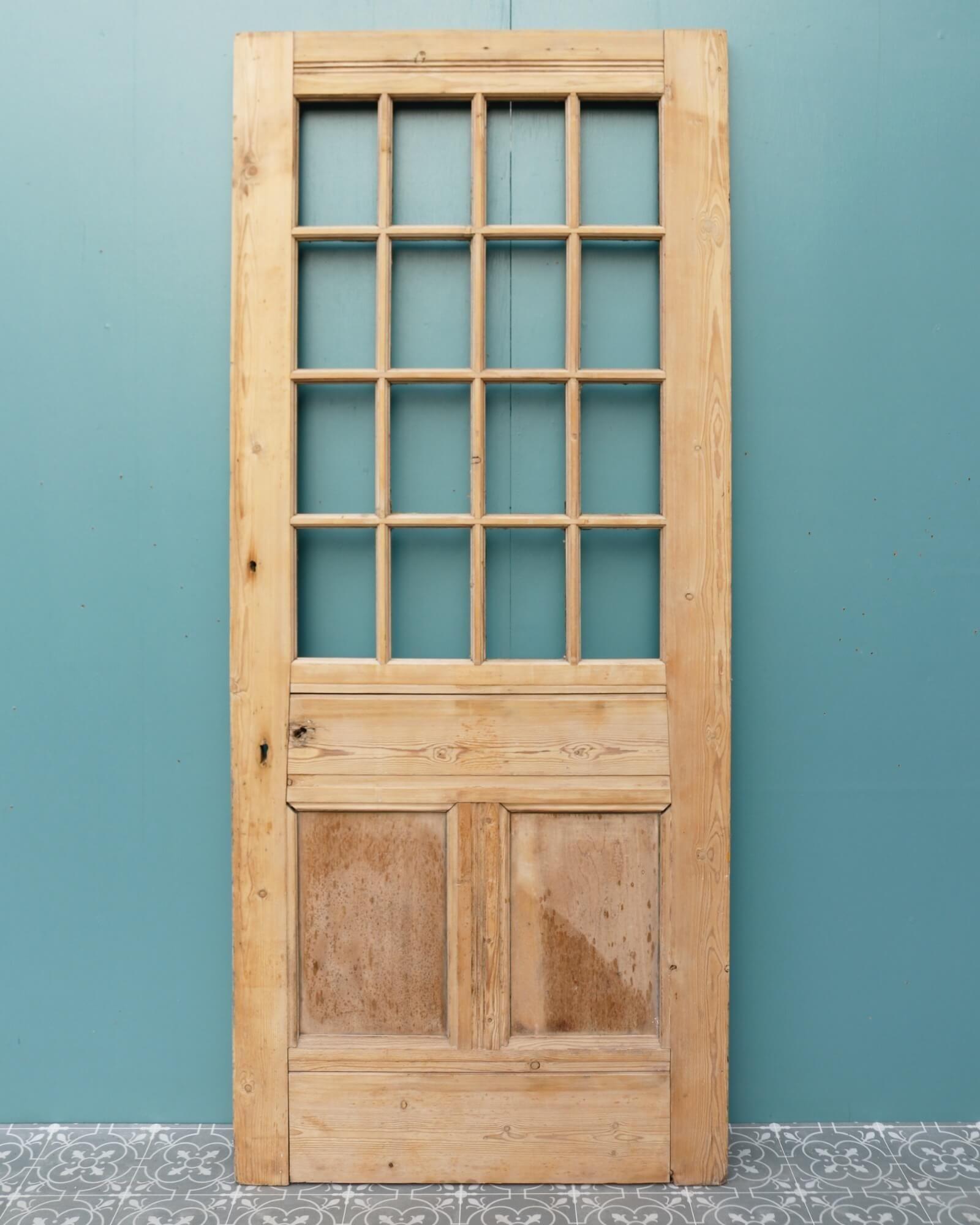 An unglazed, reclaimed Victorian front door circa 1890, stripped and sanded and ready for finishing in stain, wax or paint. Features 2 panel construction at the base to the front and the back below 16 panes for glazing. With the glass fitted and the