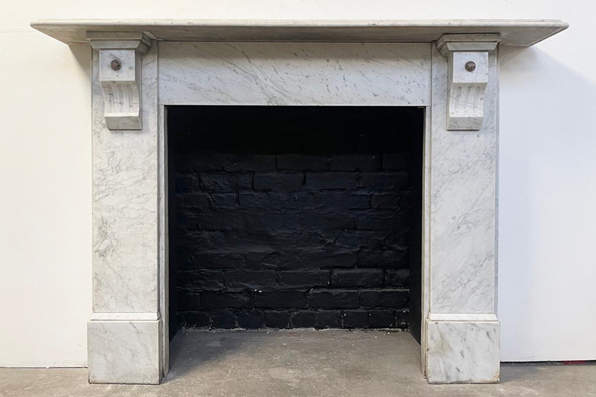 Reclaimed Victorian carrara fireplace surround with substantial fluted corbels with applied rouge marble bosses supporting the ogee moulded shelf. circa 1880.

Awaiting restoration, priced once fully restored. Can be restored with or without the