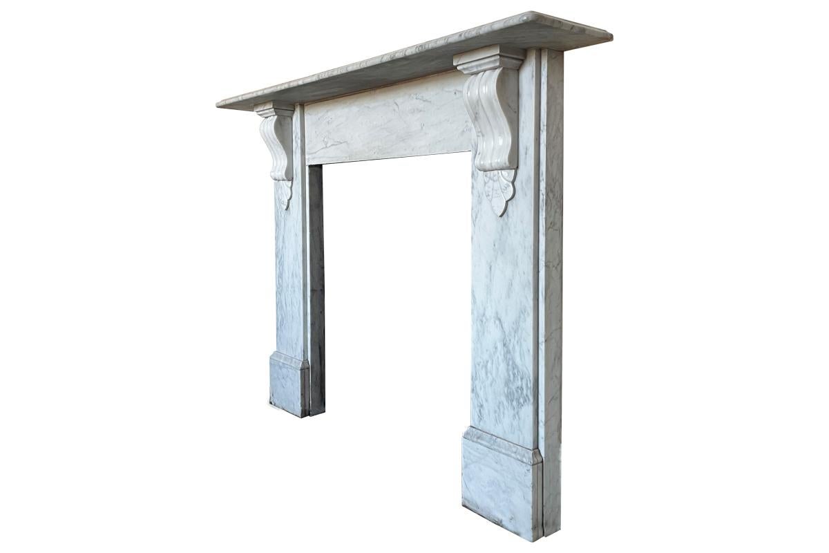 Reclaimed Victorian carrara marble fireplace surround with carved corbels supporting the shelf. circa 1880.

Awaiting restoration, priced once fully restored.

For detailed sizes please see the size diagram within the image gallery.