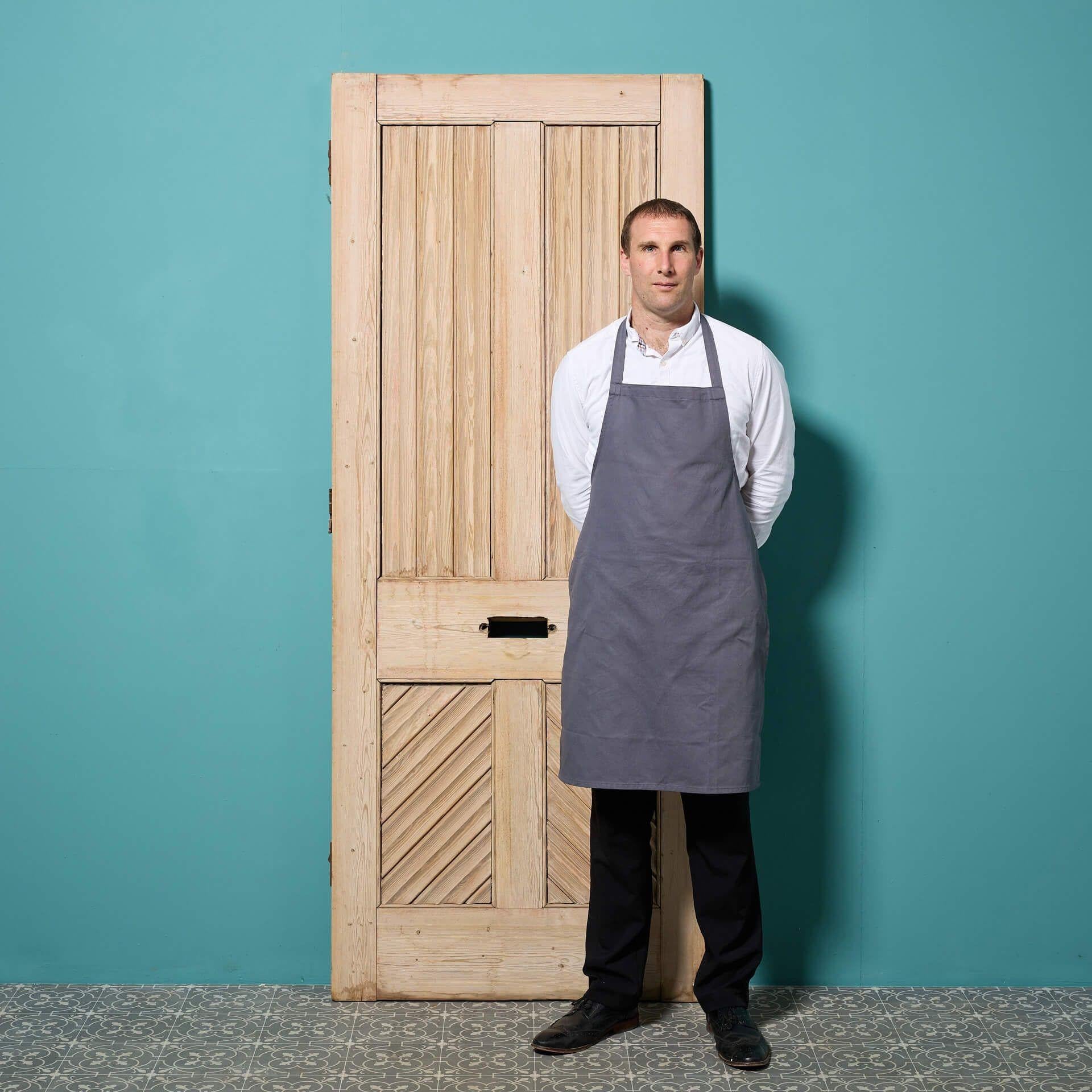 An unusual reclaimed Victorian four panel front door with fluted mouldings to the front panels and standard panels to the reverse. With a stripped finish, this antique pine door is ready for applying with paint, stain or wax as desired, making a
