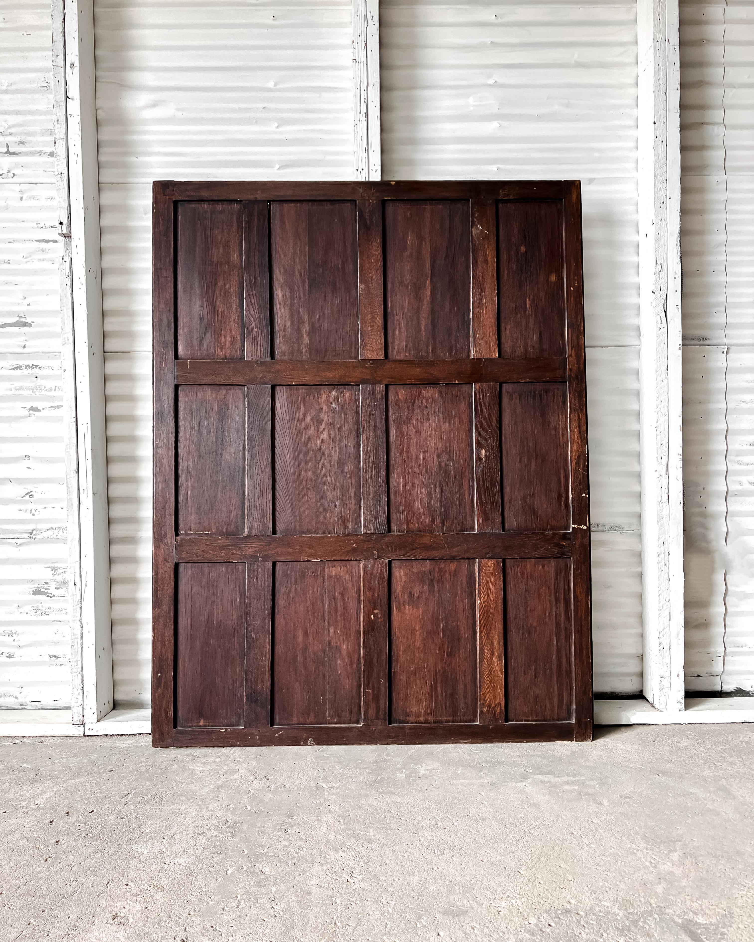Salvaged in England, this reclaimed Victorian English oak wall panel, having 12 panels, bears the original medium to dark stained finish. Originally attached to a wall among a series of panels, this single panel is now a decorative architectural