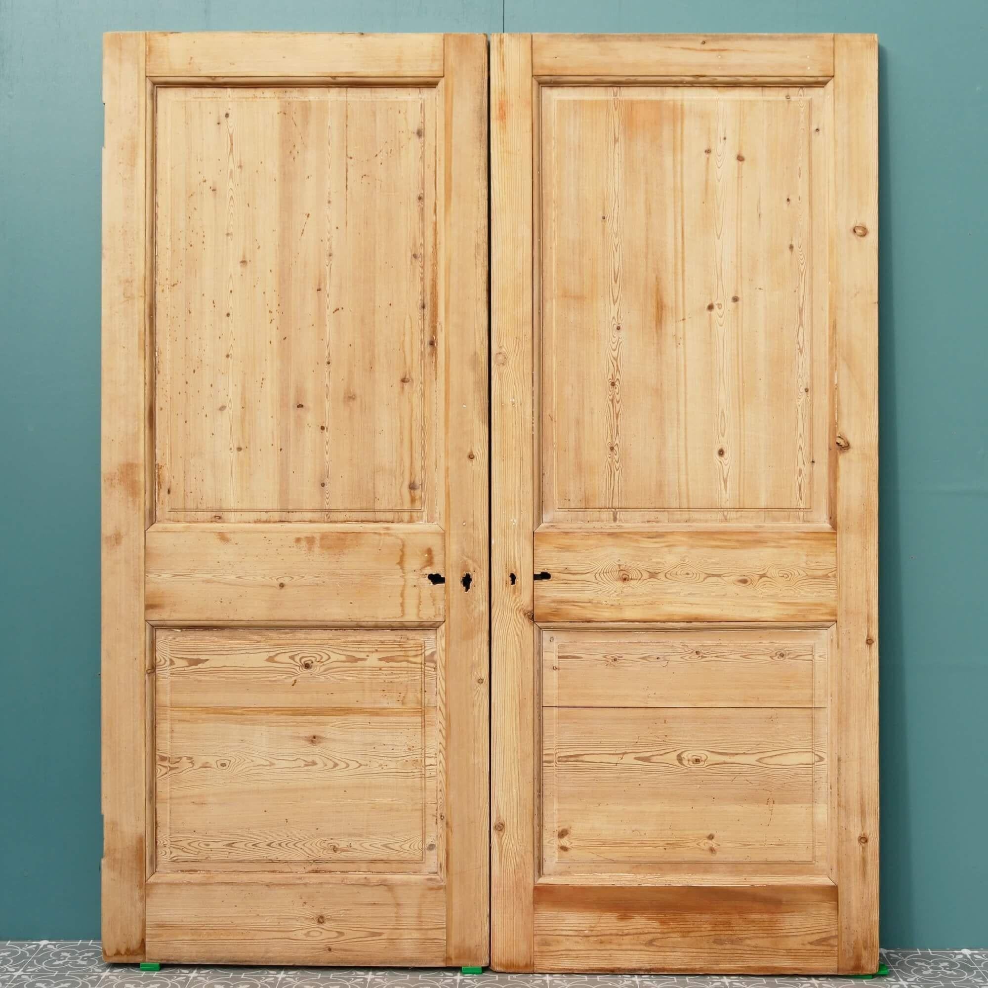 A pair of reclaimed Victorian pine internal double doors dating from the early 20th century. These antique double doors make beautiful set of dividing doors in a period townhouse or traditional cottage. Detailed with smart raised and fielded panels