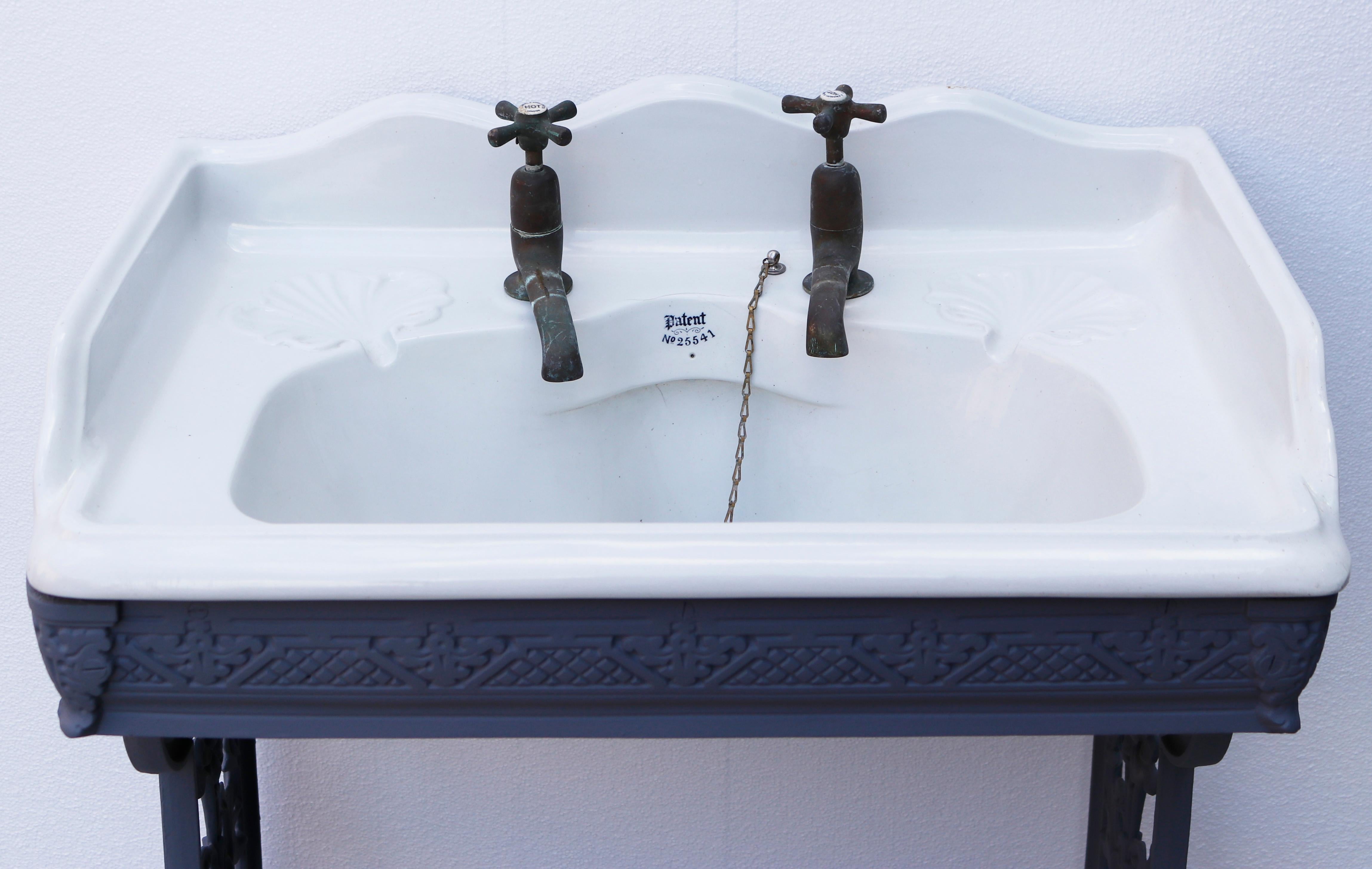 An Attractive Antique Victorian Porcelain sink with cast iron stand.