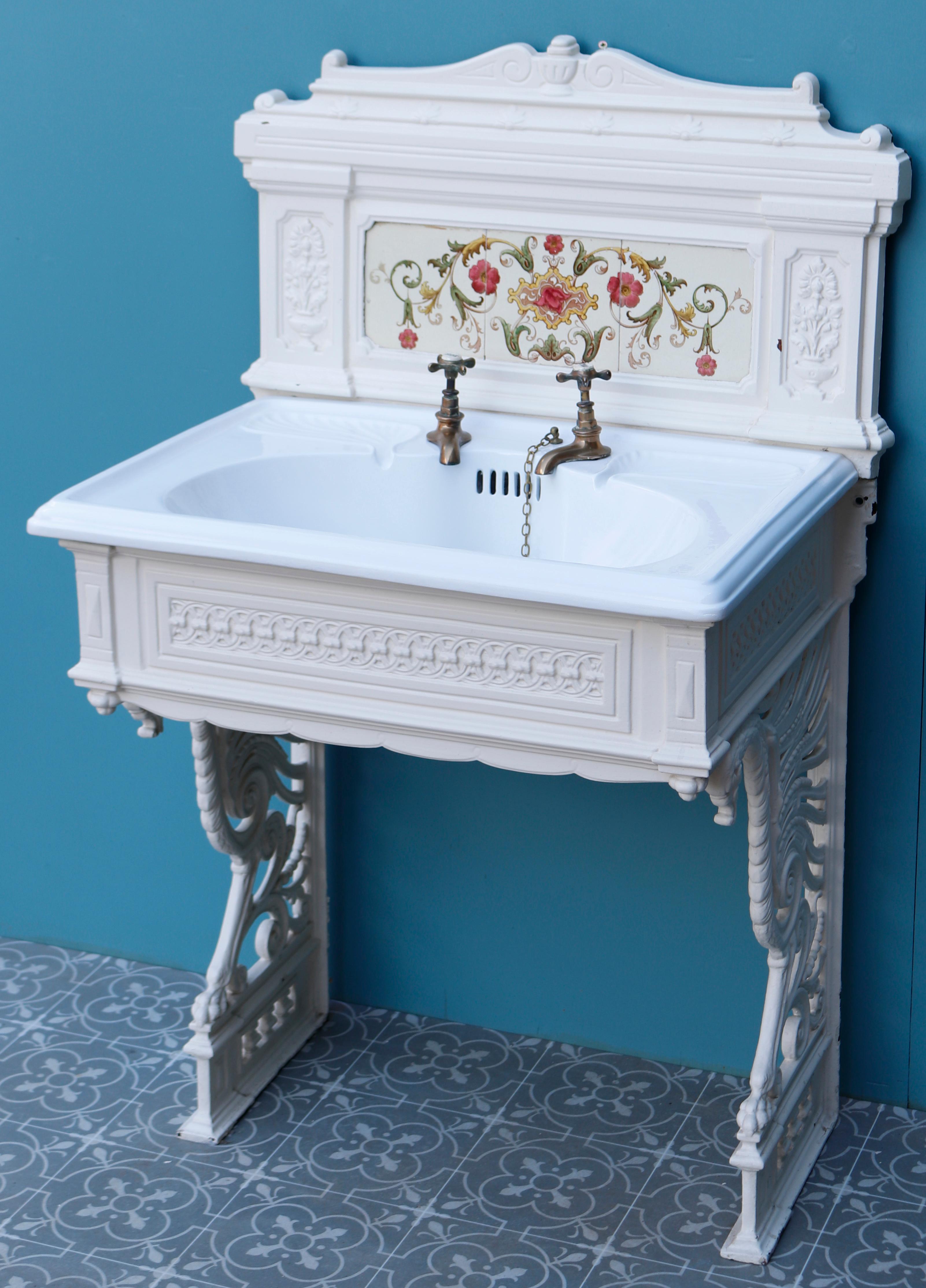 An attractive Victorian style wash stand with tiled cast iron splash back, cast iron stand and porcelain bowl. The sink includes the original taps, plugs, chains and waste. The tiles are original.

We have another identical set