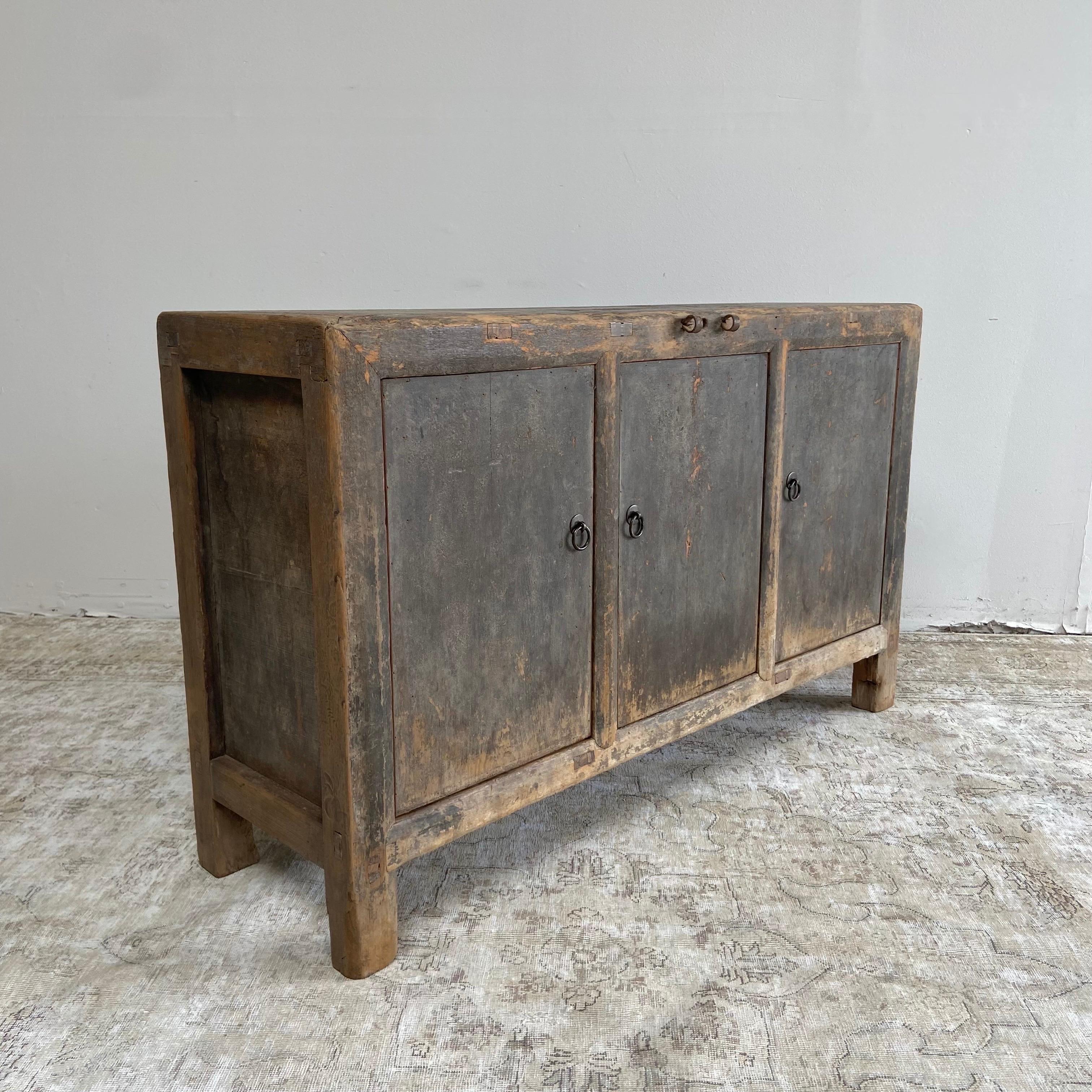 Vintage faded black cabinet 
size: 52”W x 16”D x 31-1/2”H
This faded black, charcoal cabinet has original distressed paint patina.
Constructed from vintage reclaimed timbers, with 3 working doors that open up to lots of great storage. This is a