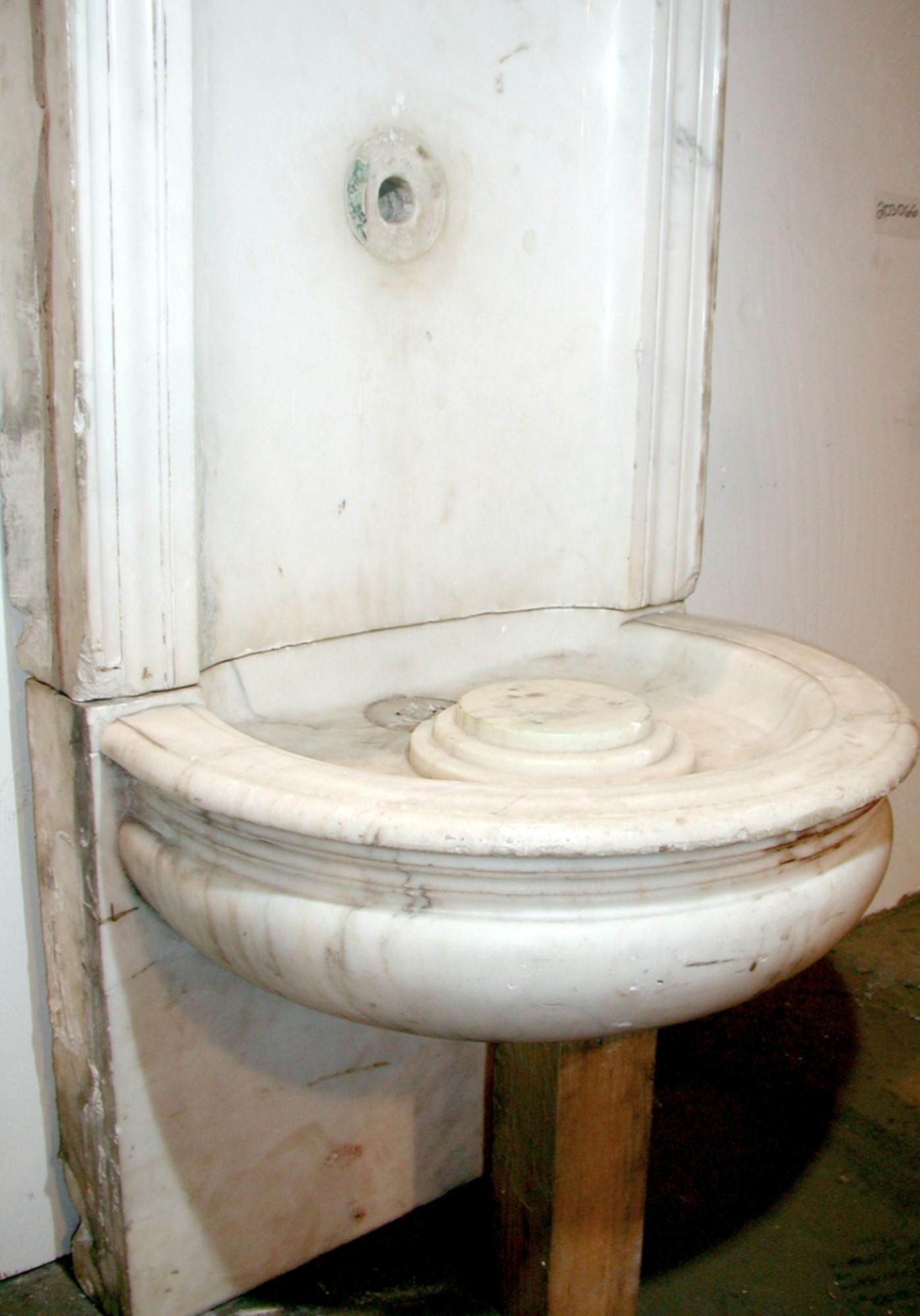 Marble fountain retrieved from the interior of a Wall Street building in New York City. Minor chips around the edges as it was built into a wall. Unfinished sides. No original fixtures, pumps, or motors are included. Small quantity available at time