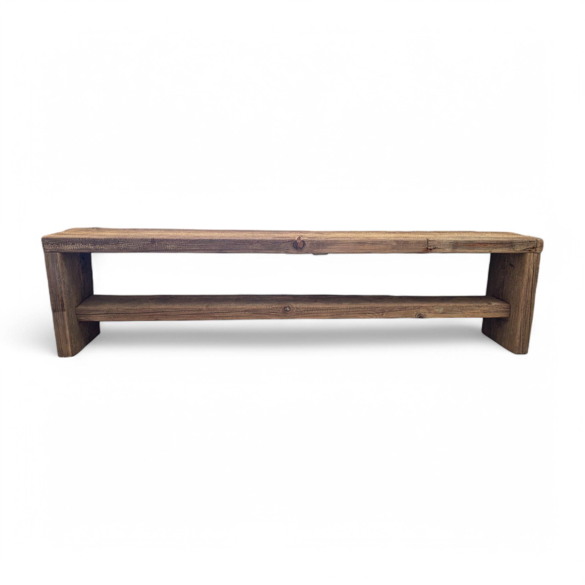 Crafted from reclaimed wood, this bench brings warmth and character with its natural grain and rustic finish. The clean-lined design and lower shelf make it both stylish and functional, perfect for entryways, living spaces, or the foot of a bed. A
