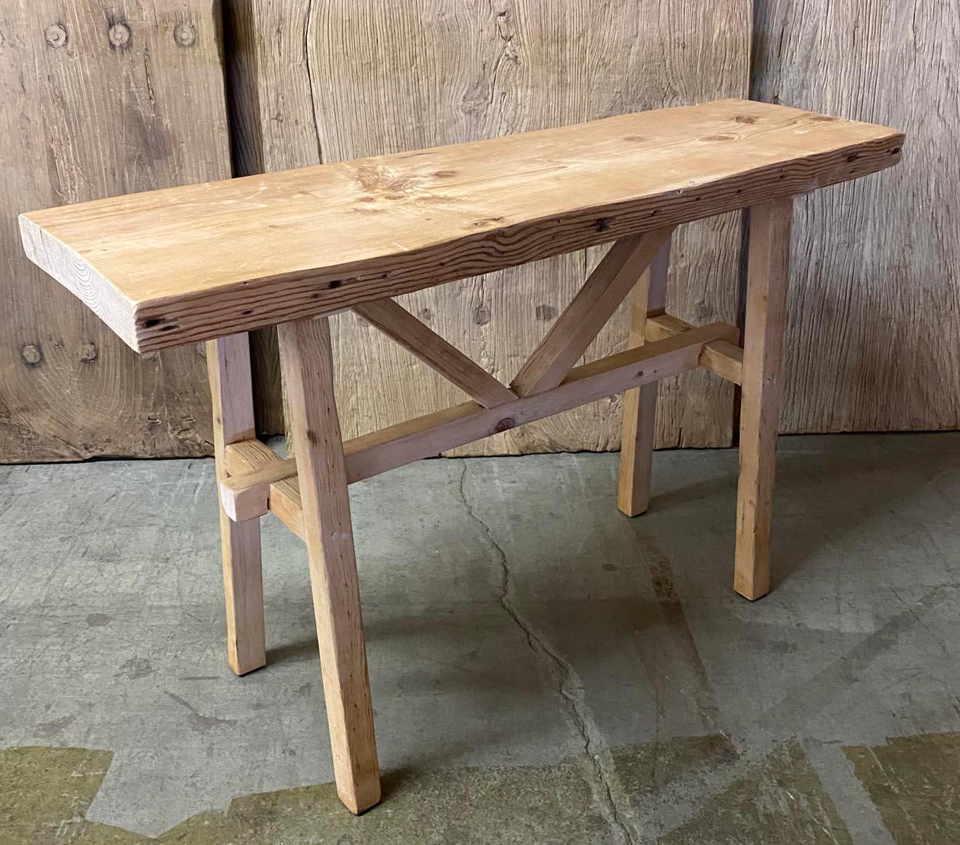 This console is made from vintage reclaimed Douglas fir. It shows age appropriate wear such as old cracks and nail holes but has a smooth finish. Raw, natural wood with a dead flat finish.